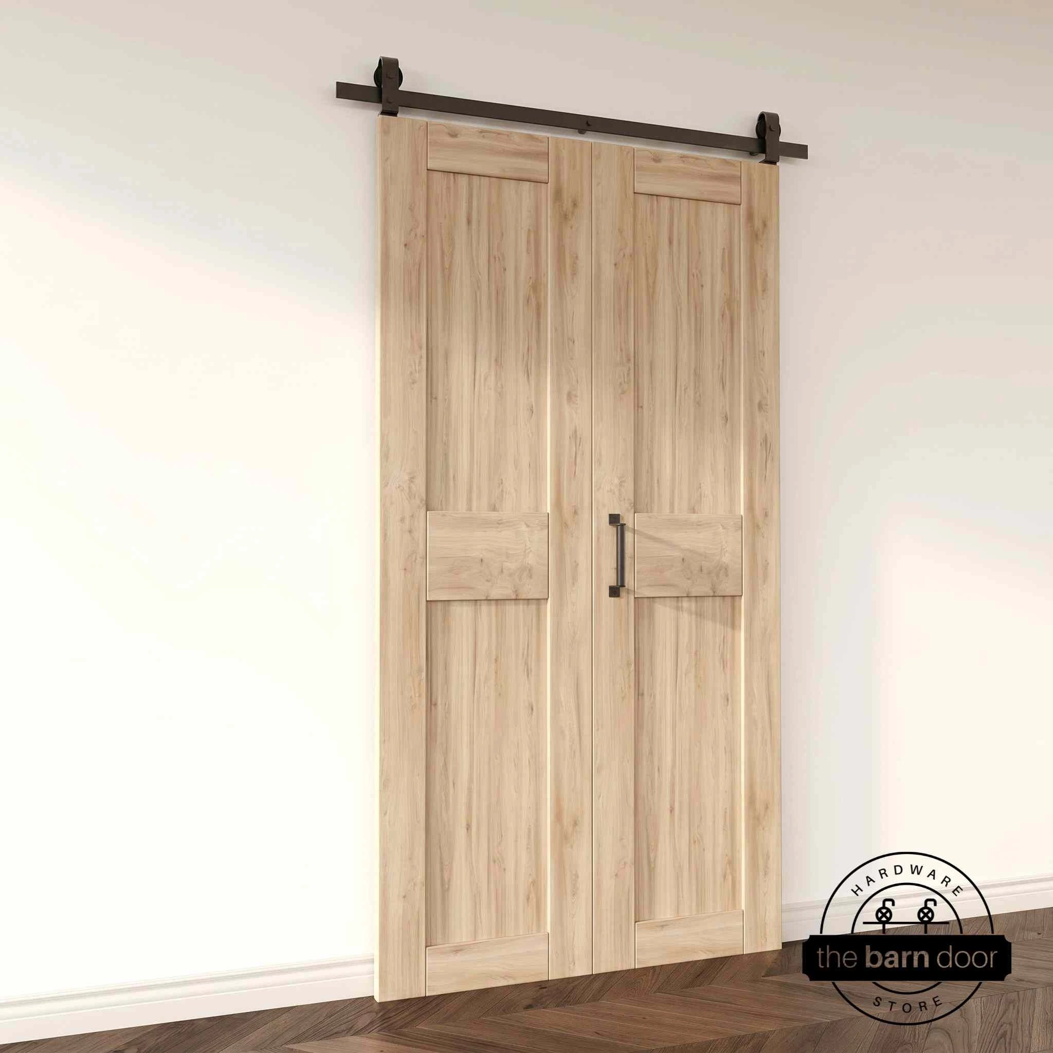 Two-panel bifold barn door unfinished, installed and fully closed in a modern interior, showing the top-mount Matte Black track.
