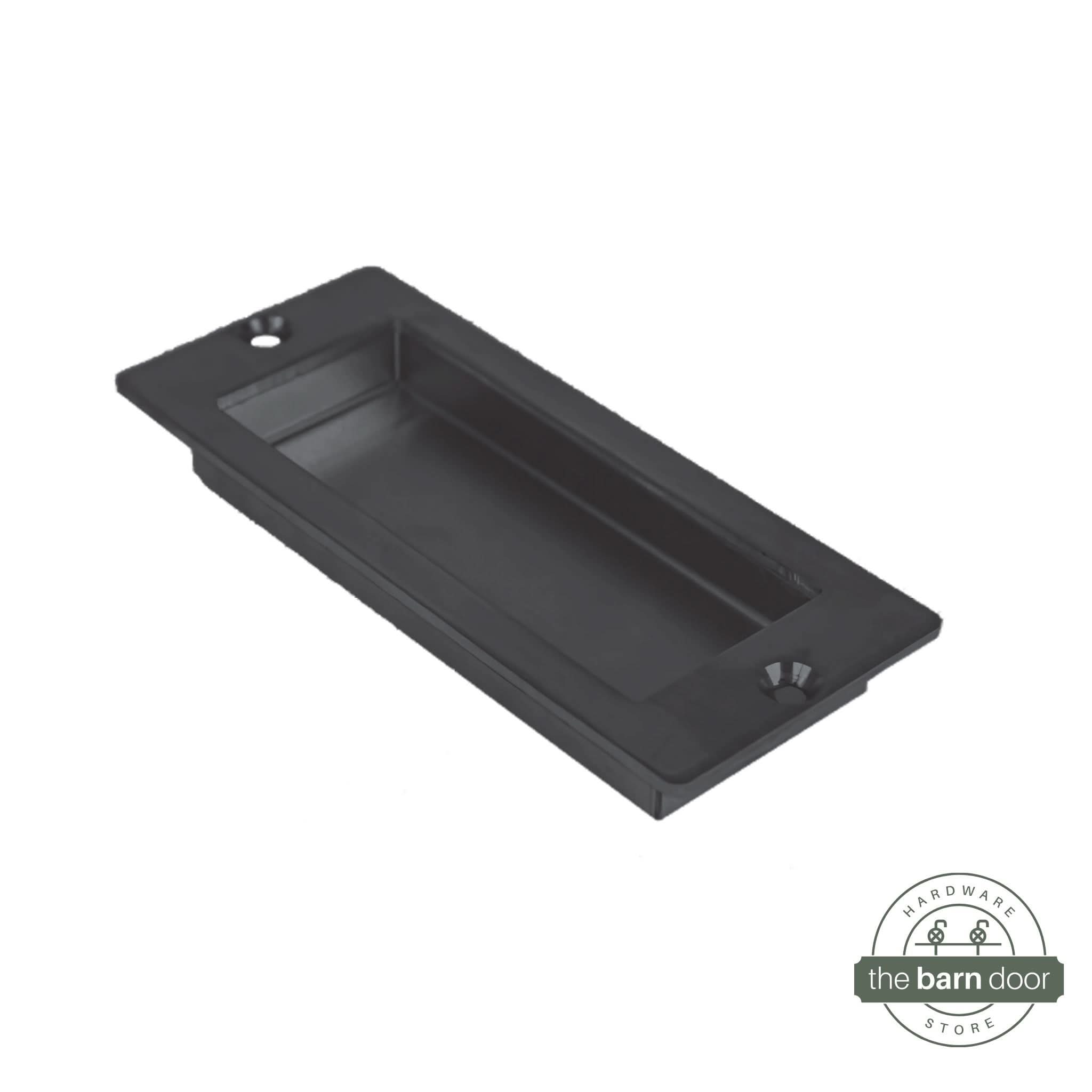 A close-up of a modern, rectangular flush pull handle with sharp, square corners, in a black finish.