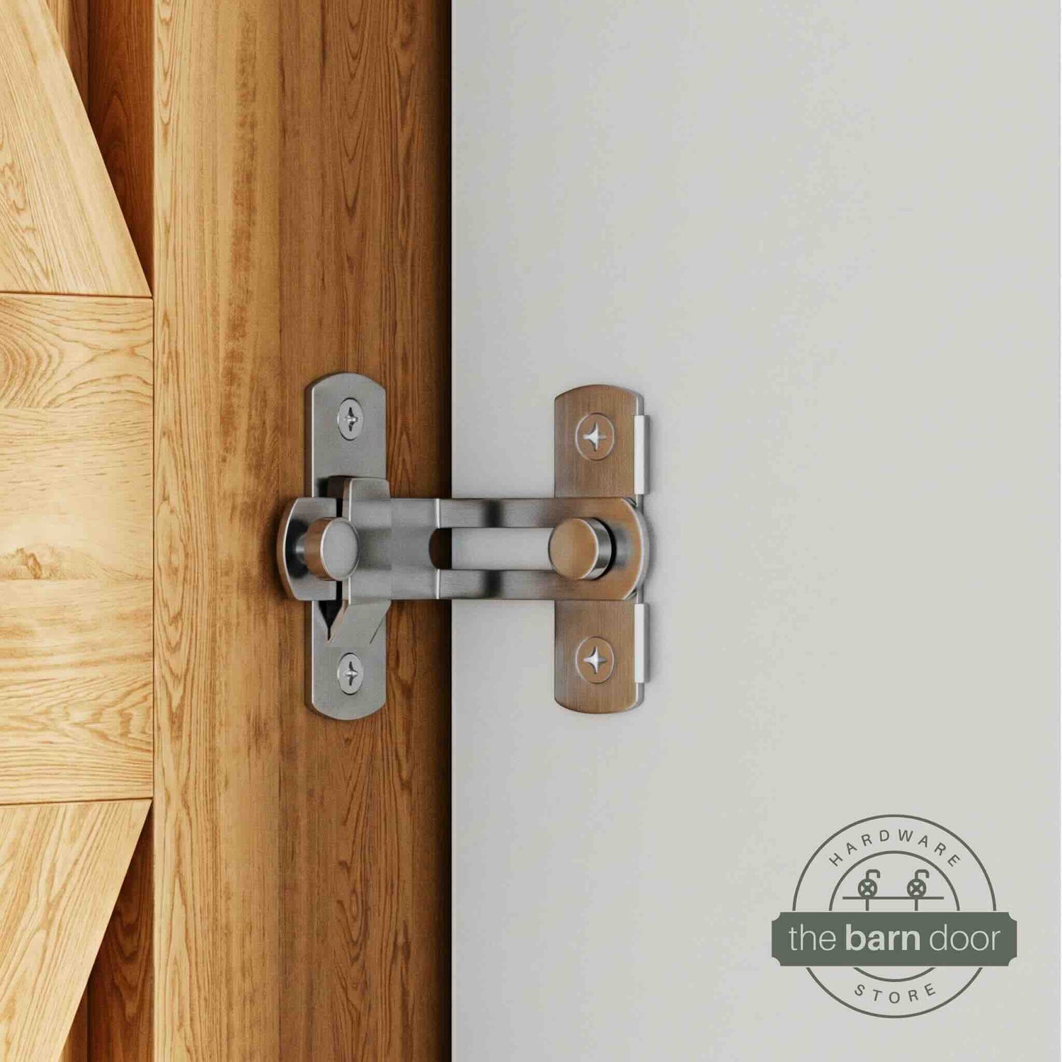 Stainless steel 90-degree barn door latch installed on a sliding barn door and white wall