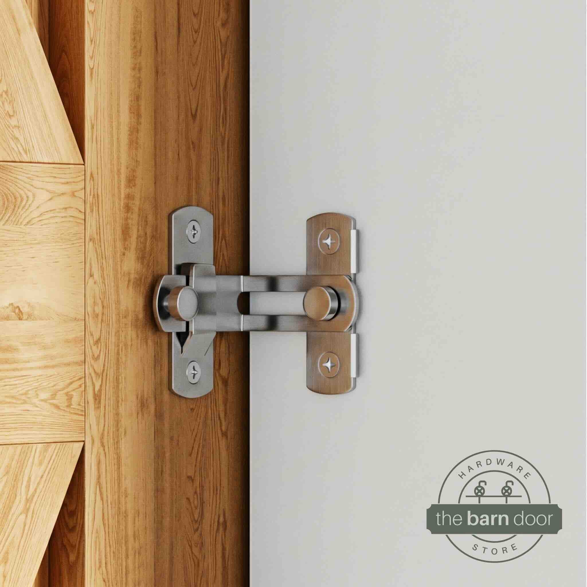 Stainless steel 90-degree barn door latch installed on a sliding barn door and white wall