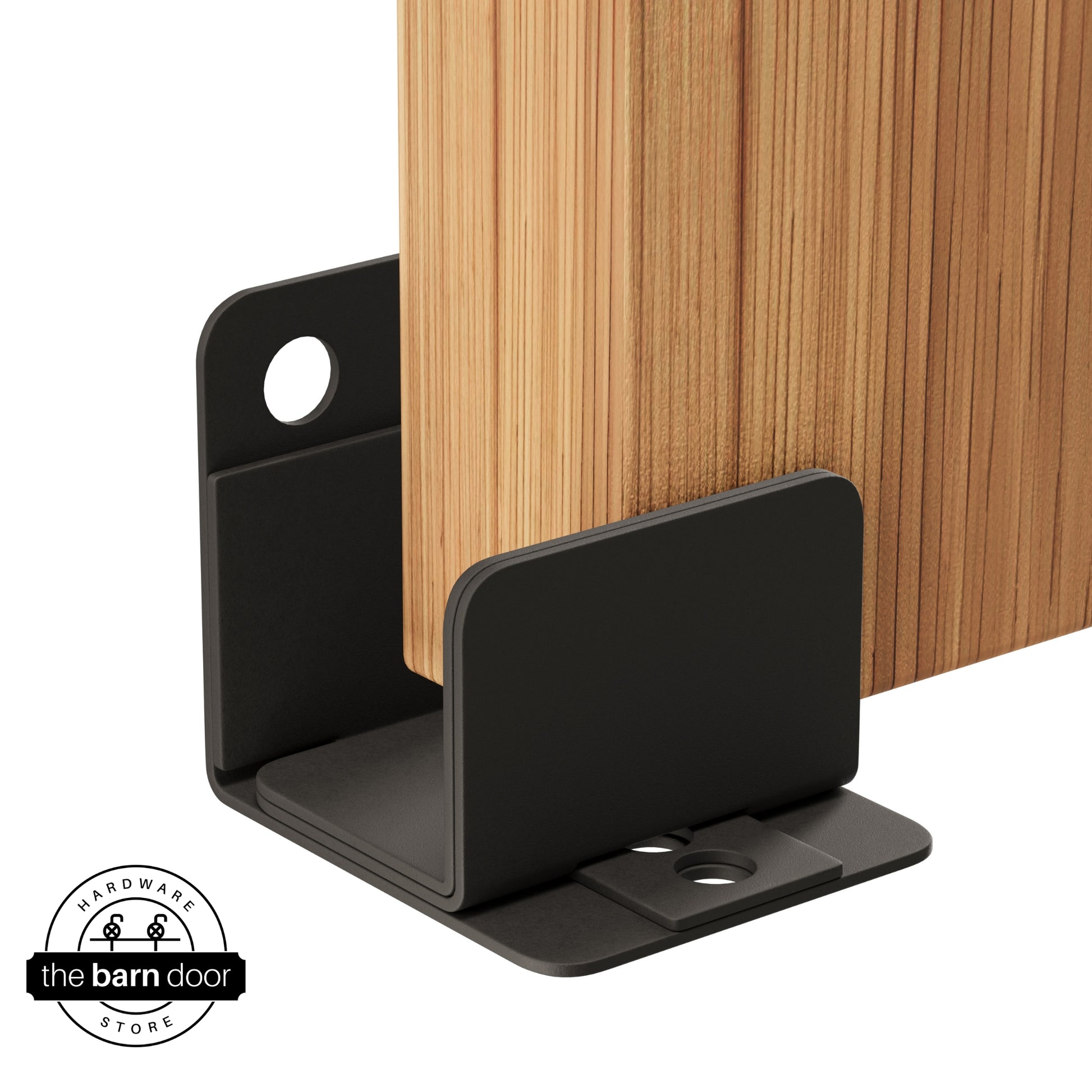An arch bronze U-shaped floor guide with a side plate, holding a light wood barn door in place.