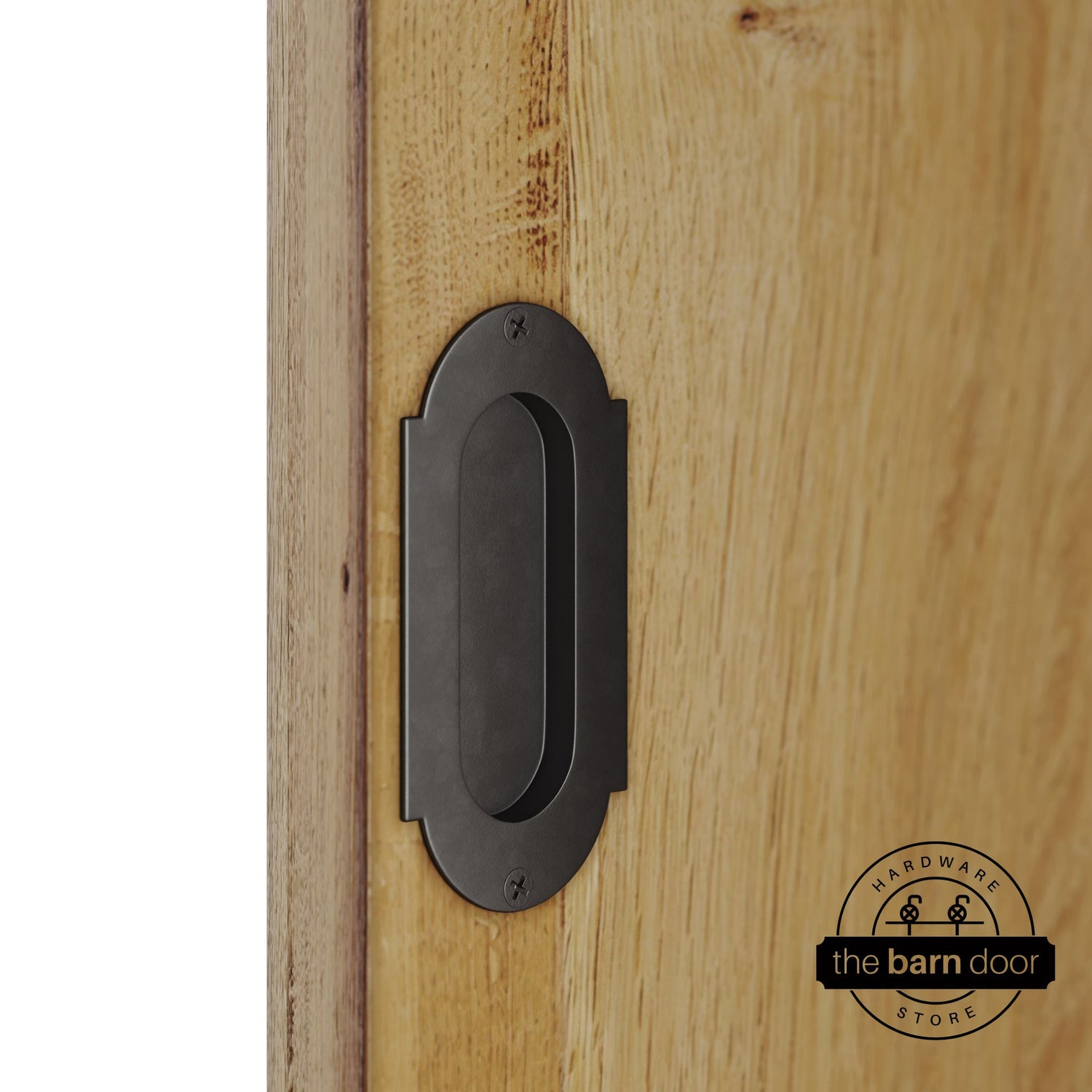 Arch bronze flush pull handle with full radius wings mounted on a light oak barn door, brushed silver finish with oval recessed grip and four mounting screws