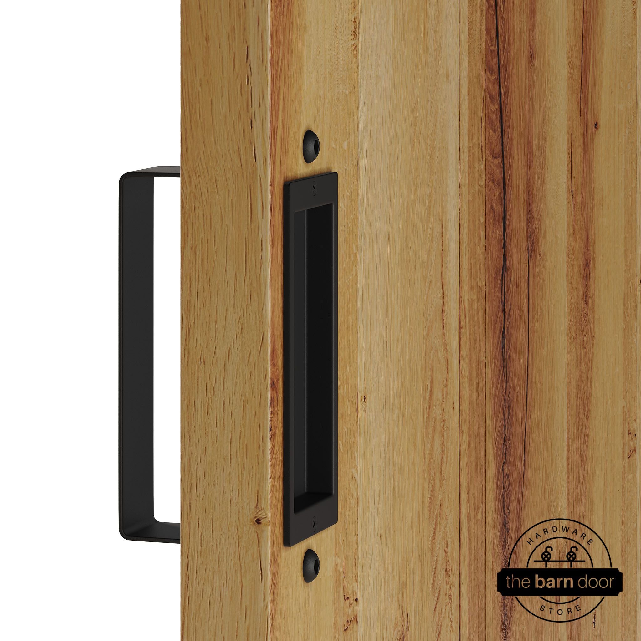 Black barn door pull handle set installed on a natural wood sliding door, featuring a rectangular U-shaped pull handle on the front face and a flush recessed pull plate on the reverse side, shown in a black finish.