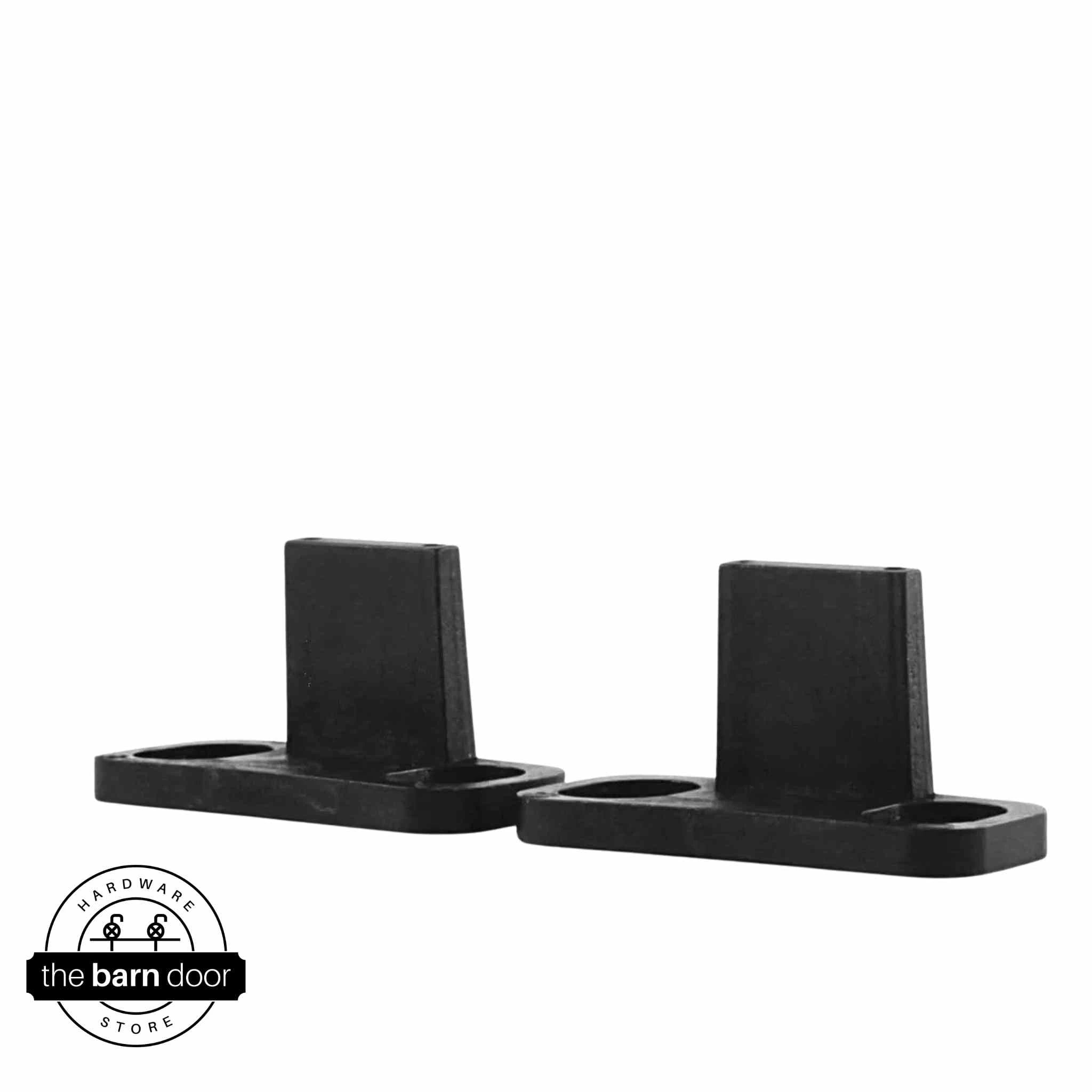 Matte black double clip barn door floor guide set with two L-shaped guides on oval mounting bases, shown on white background