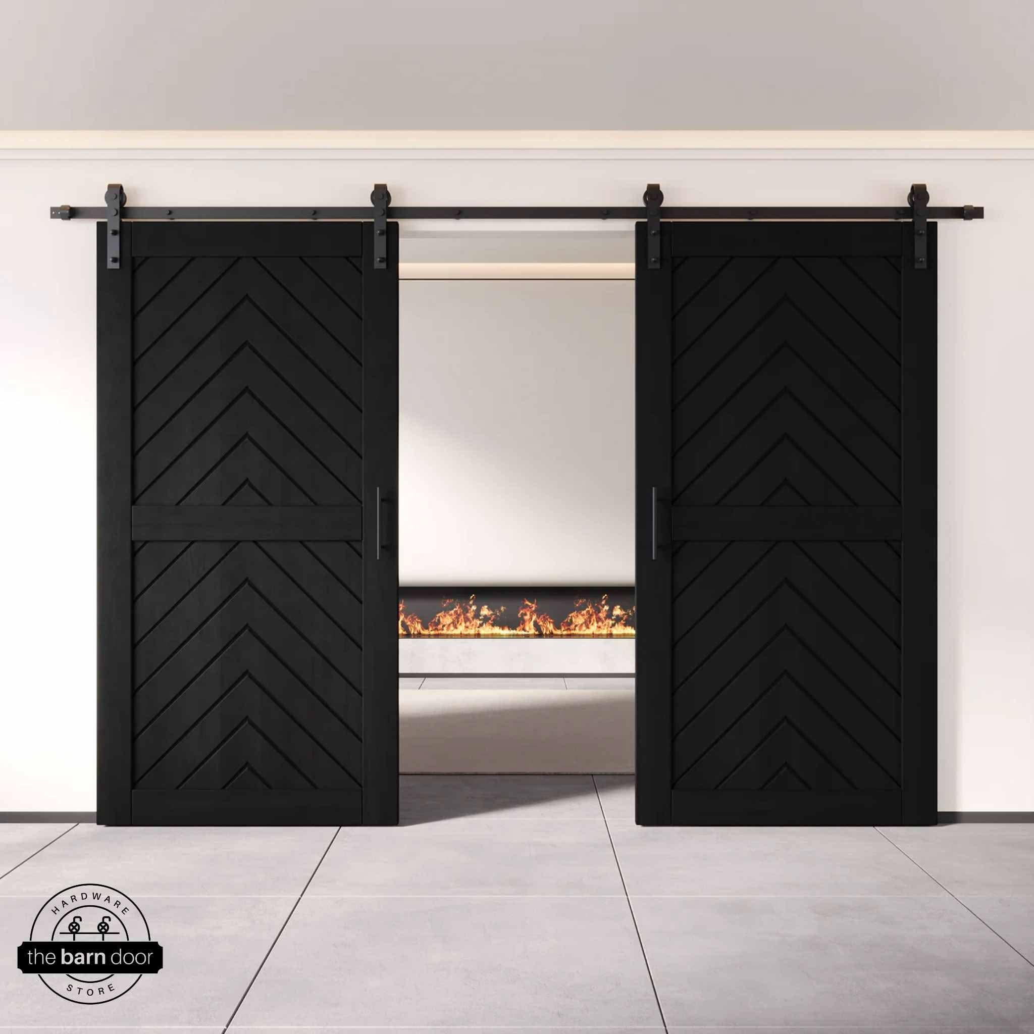 Black wooden barn doors with a chevron pattern on a white wall background