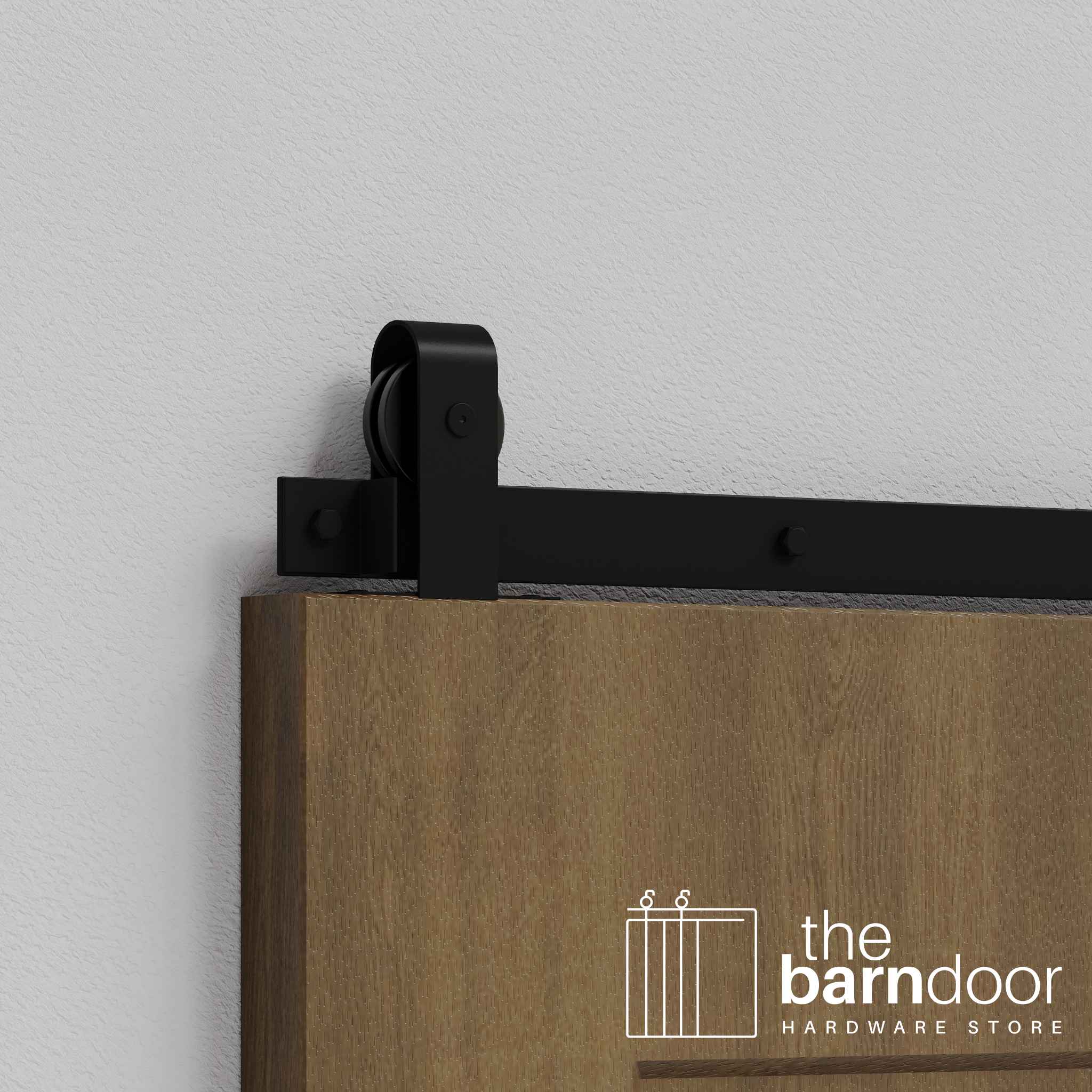Close-up of Black J Top Mount Single Track barn door hardware installed on a wooden door panel.