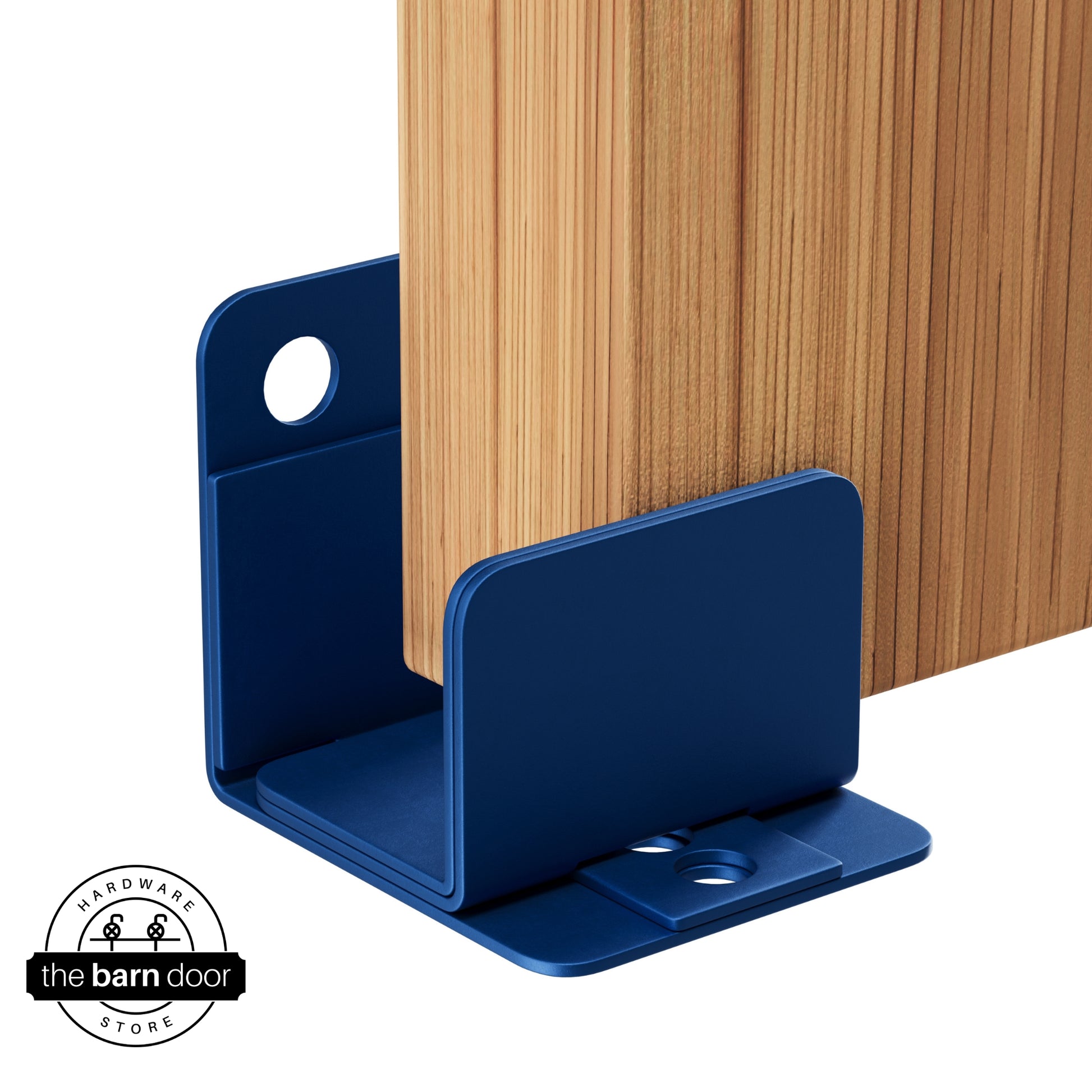 A blue ribbon U-shaped floor guide with a side plate, holding a light wood barn door in place.