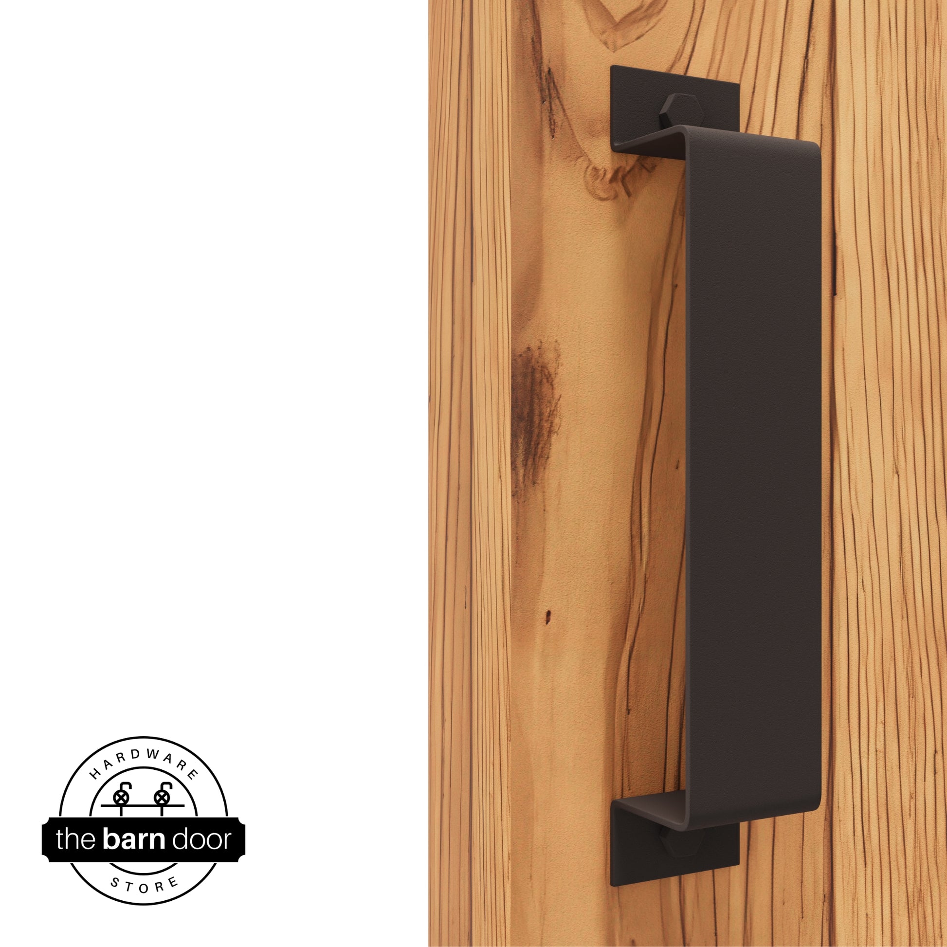 A bronze, arch-shaped barn door handle is mounted on a light-colored wooden door with a vertical grain pattern.