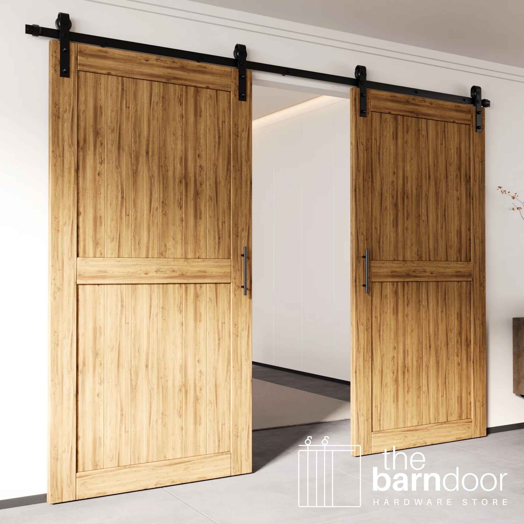 Two beautiful wood doors installed as a bi-parting double door system, using the classic J-strap sliding barn door hardware kit.