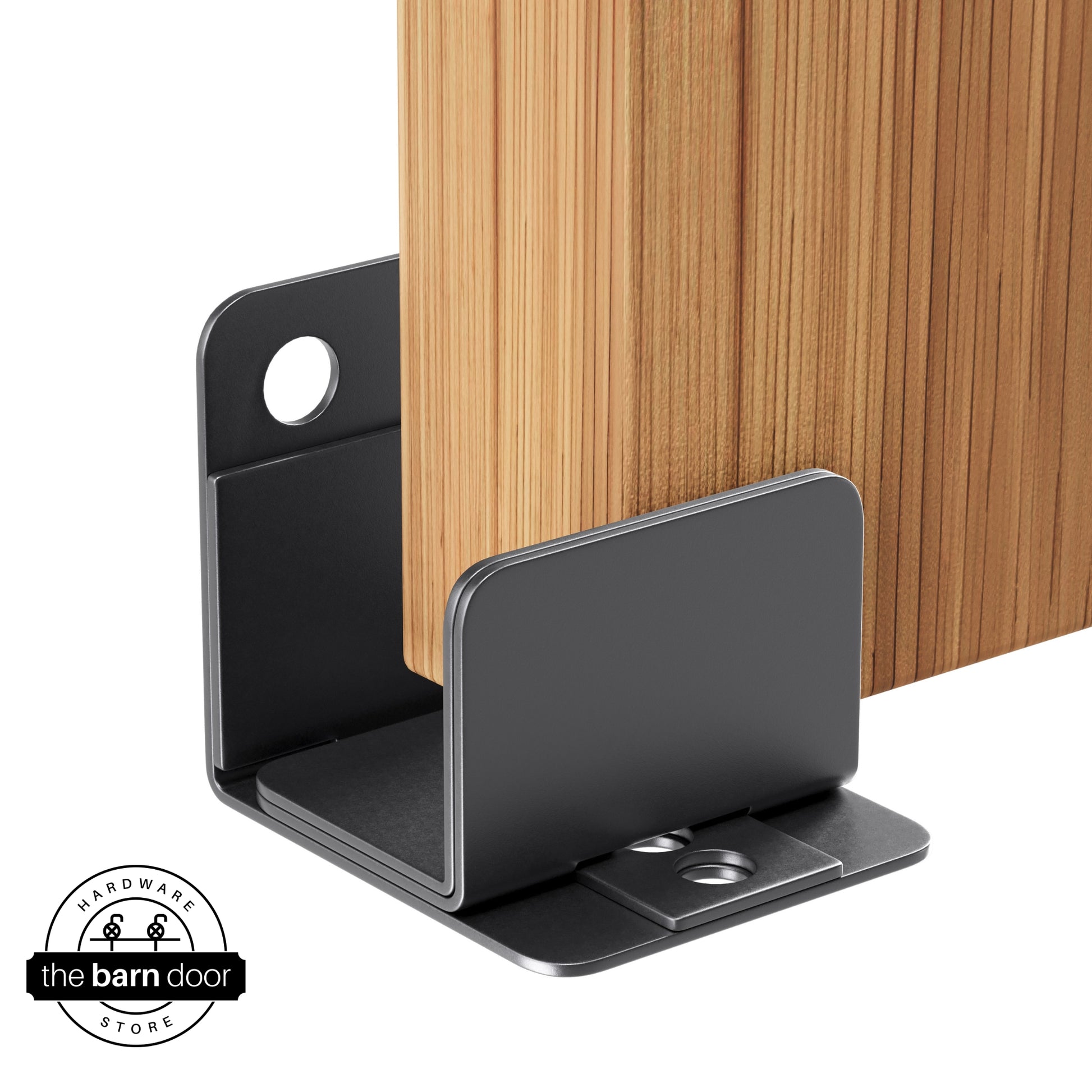 A dark gray U-shaped floor guide with a side plate, holding a light wood barn door in place.