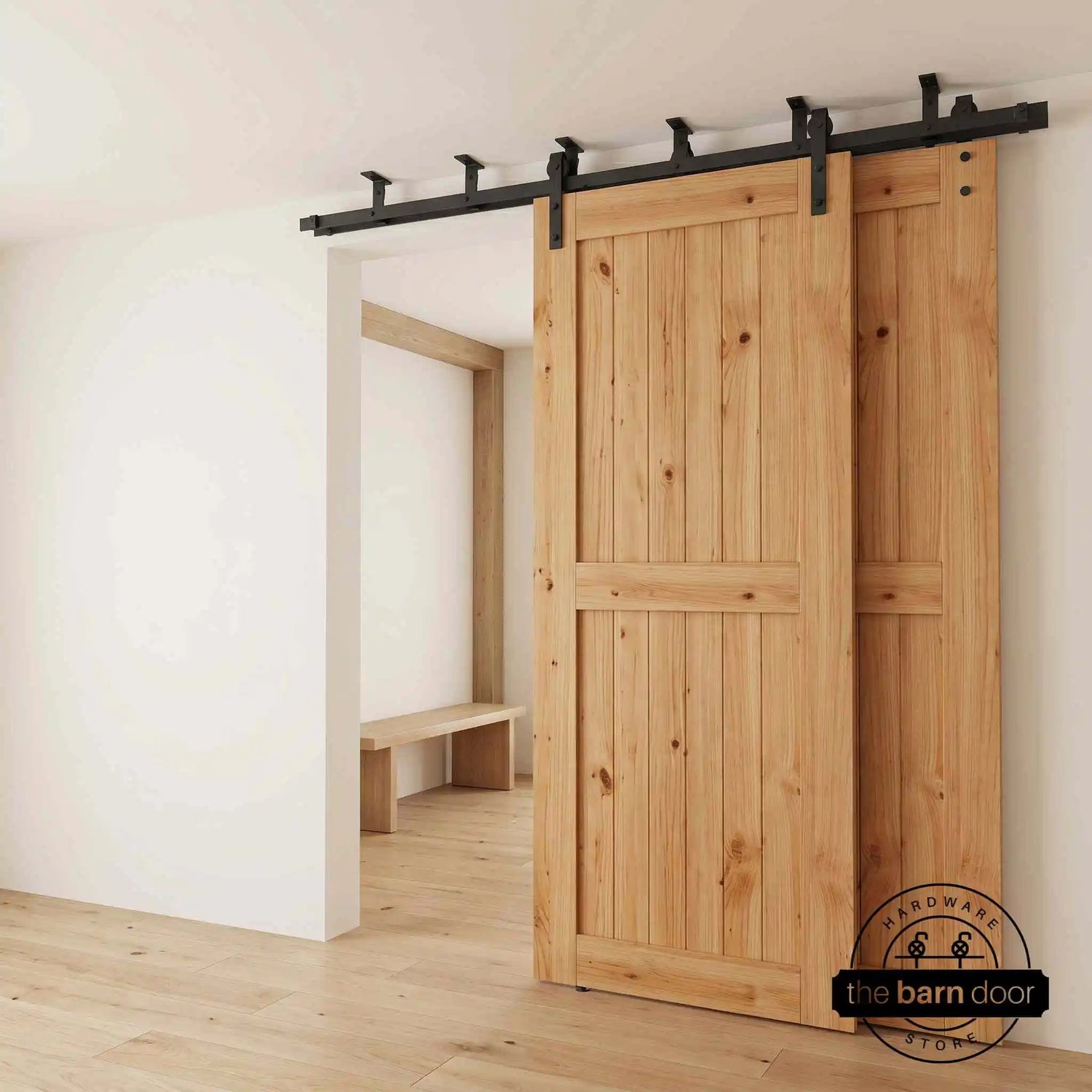Two sliding barn doors mounted to a ceiling-mounted double bypass track system in matte black finish with black roller wheels