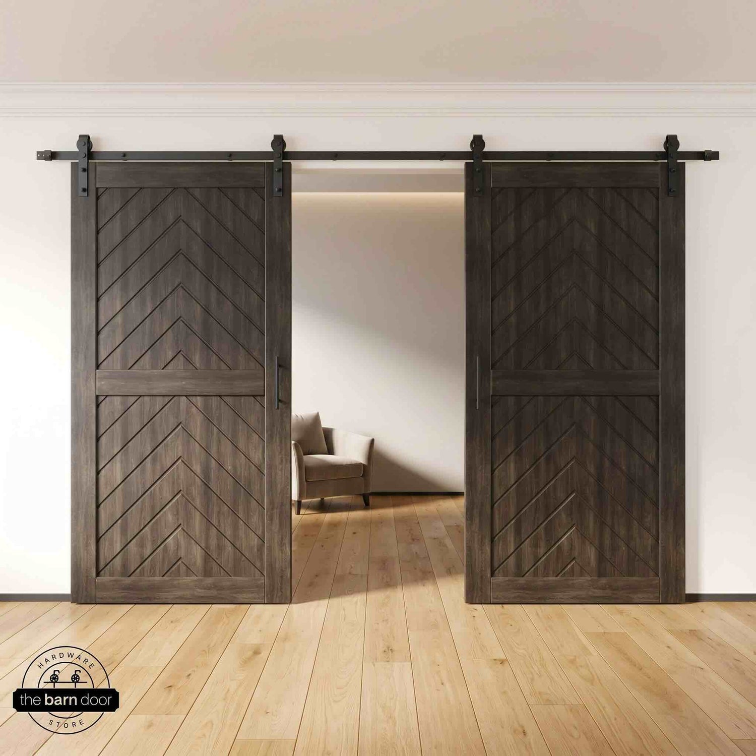 Ebony wooden barn doors with a chevron pattern on a white wall background