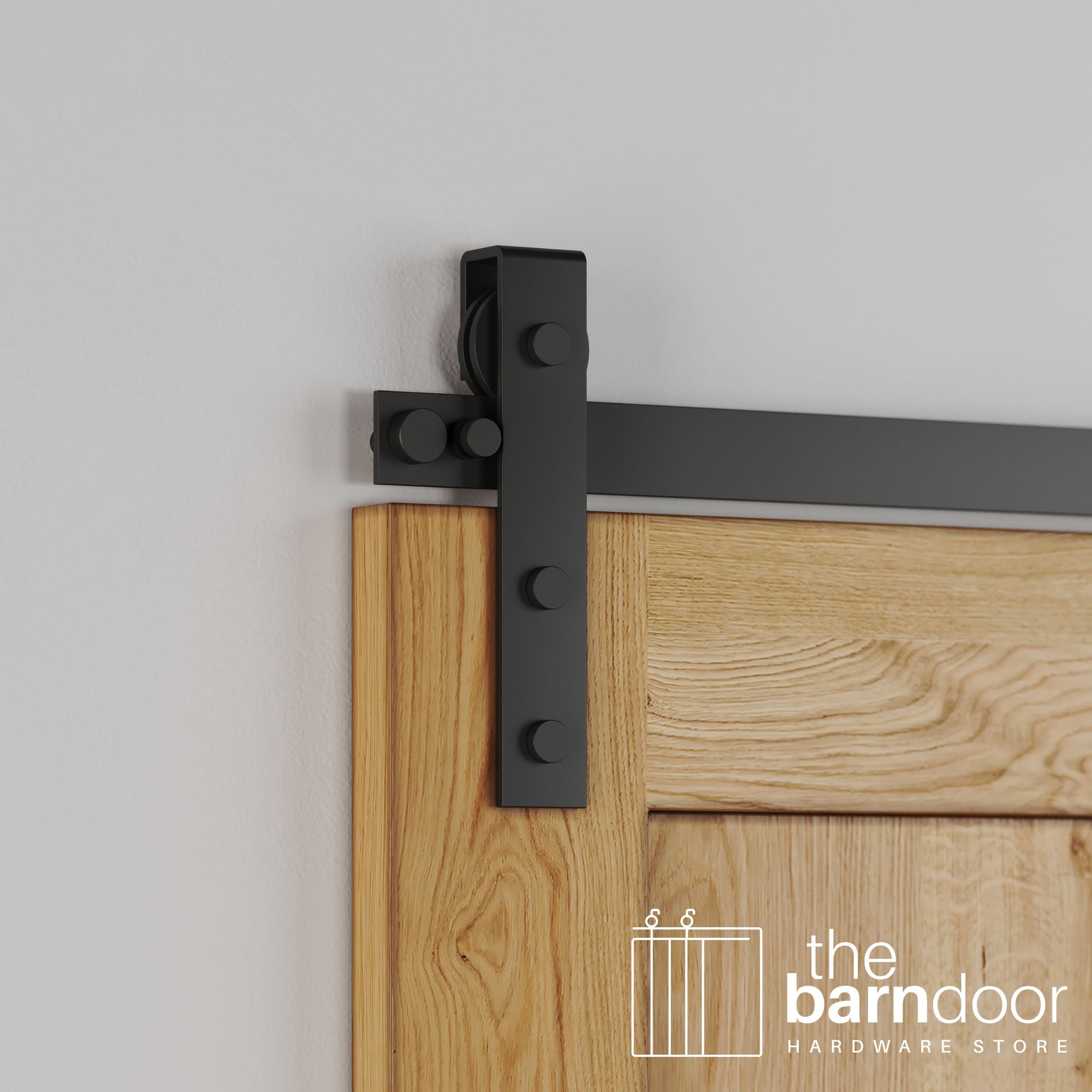 Close-up of Matte Black Flat Top Strap Stainless Steel barn door hardware installed on a natural wood door, highlighting the straight, industrial design.