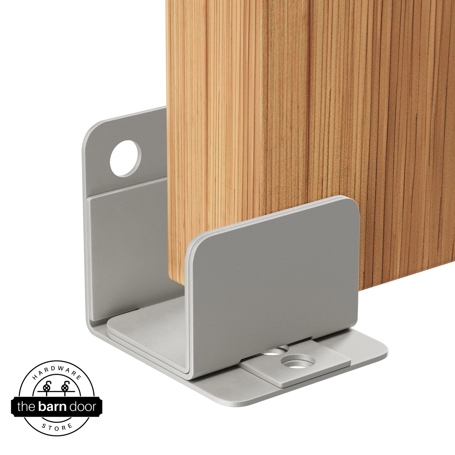 A flint gray U-shaped floor guide with a side plate, holding a light wood barn door in place.