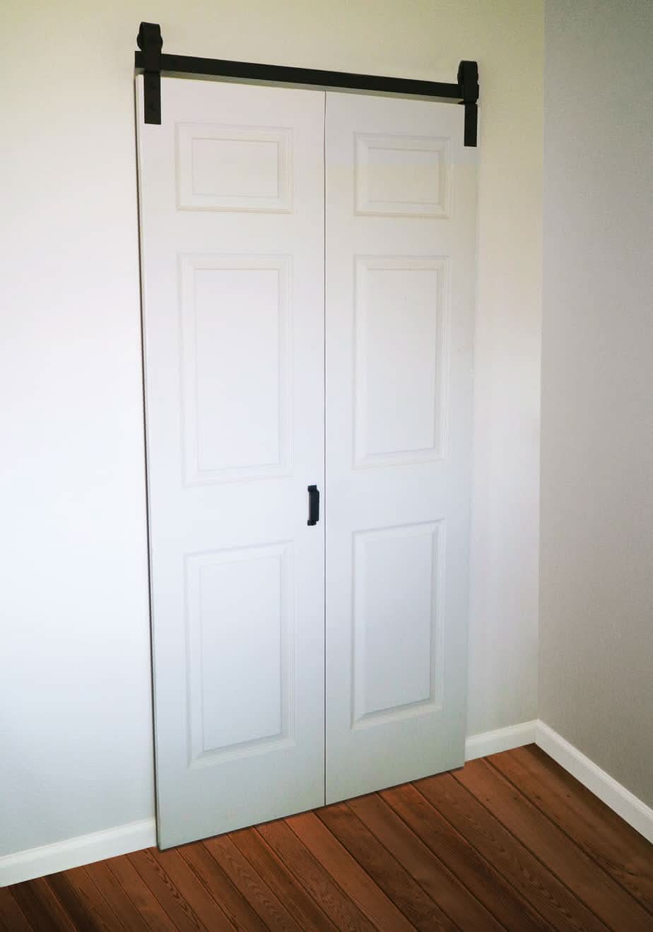 Closed Bifold Barn Doors in White with Black Track by TBDHS