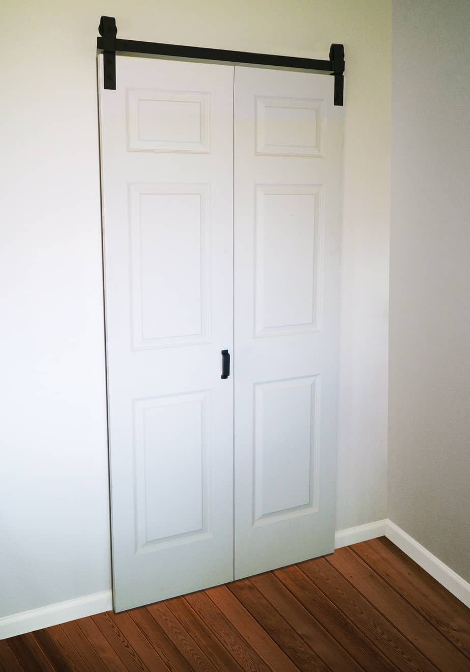 Closed Bifold Barn Doors in White with Black Track by TBDHS