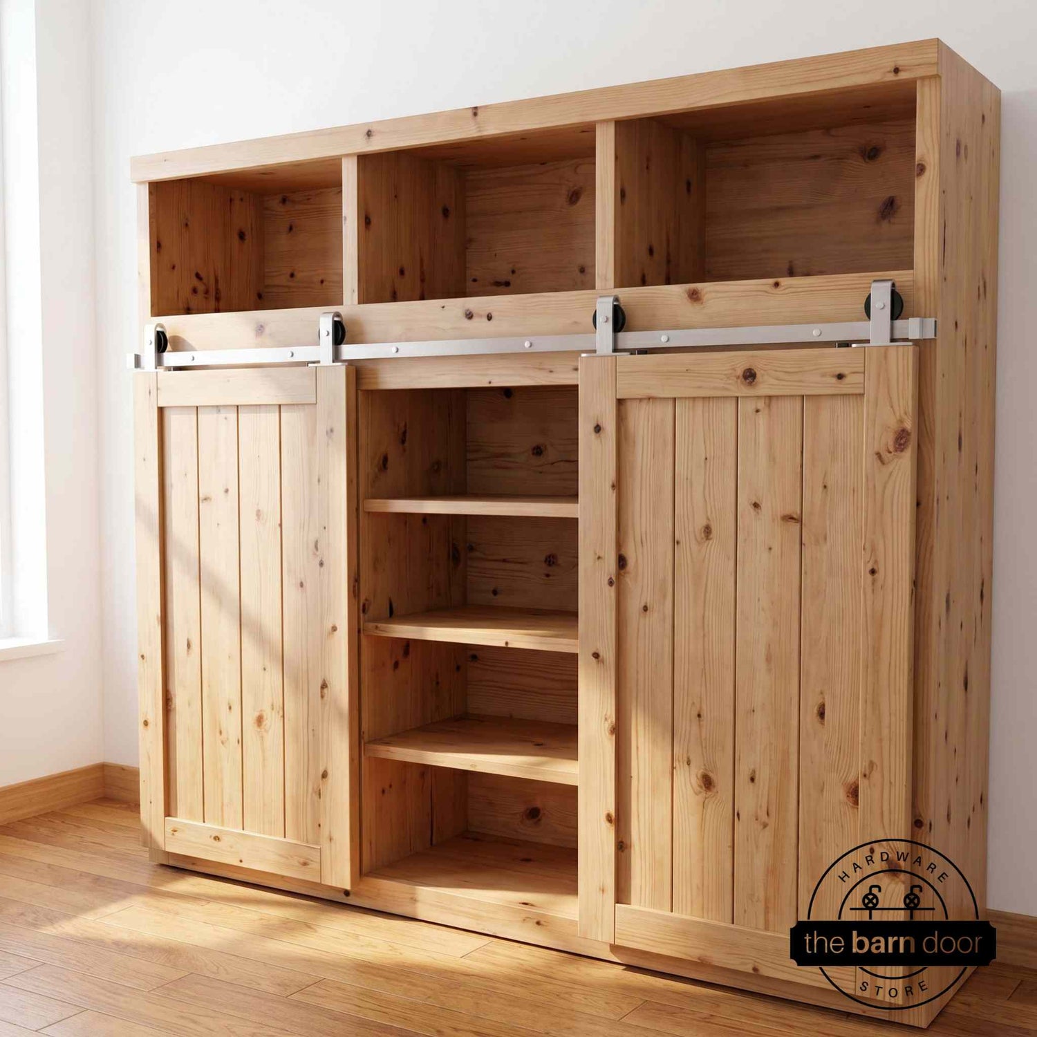 A J Top Mount cabinet barn door hardware kit in a brushed nickel finish, mounted on a small cabinet door.