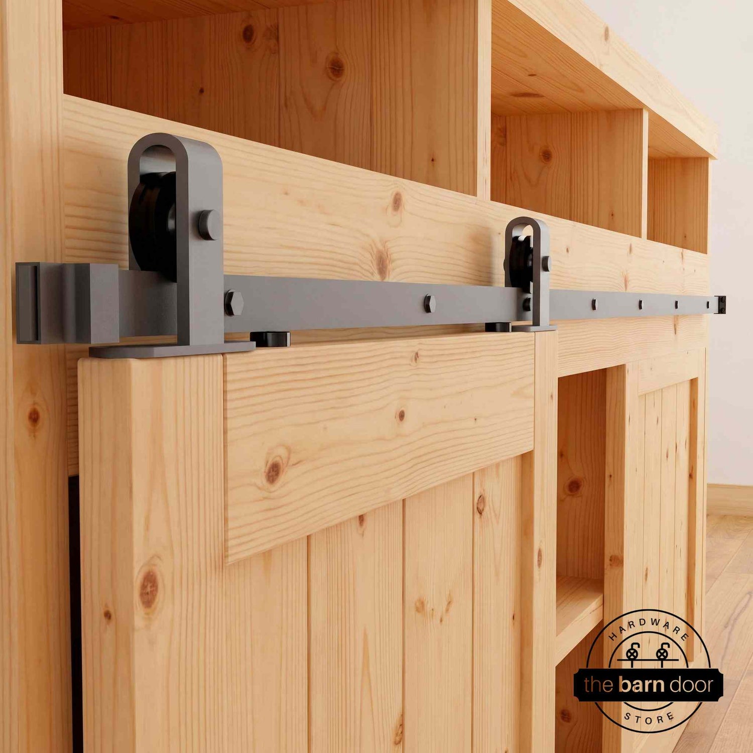 J Top Mount cabinet barn door hardware kit in matte black with a single track, shown installed on a small wooden cabinet door.