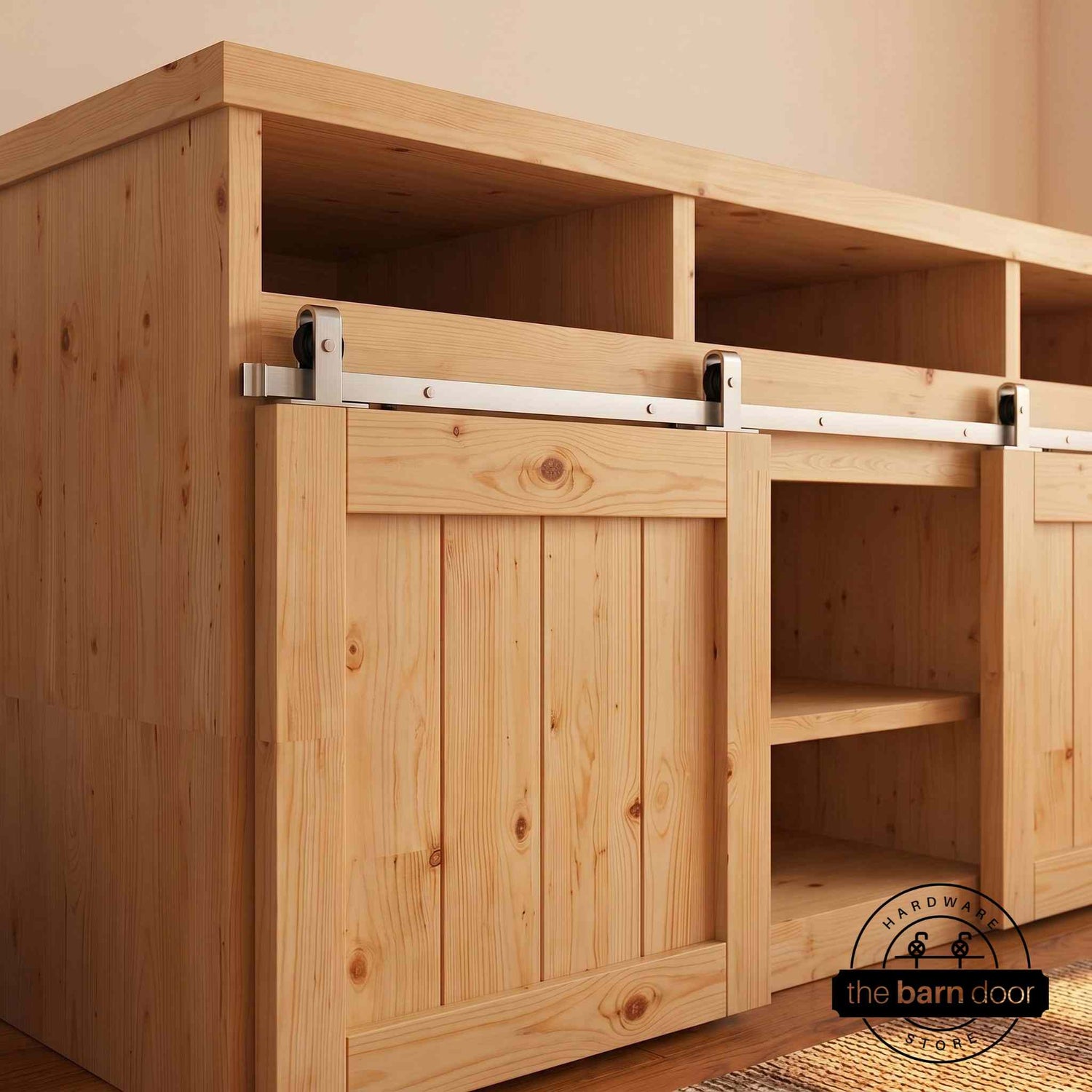 A J Top Mount cabinet barn door hardware kit in a brushed nickel finish, mounted on a small cabinet door.