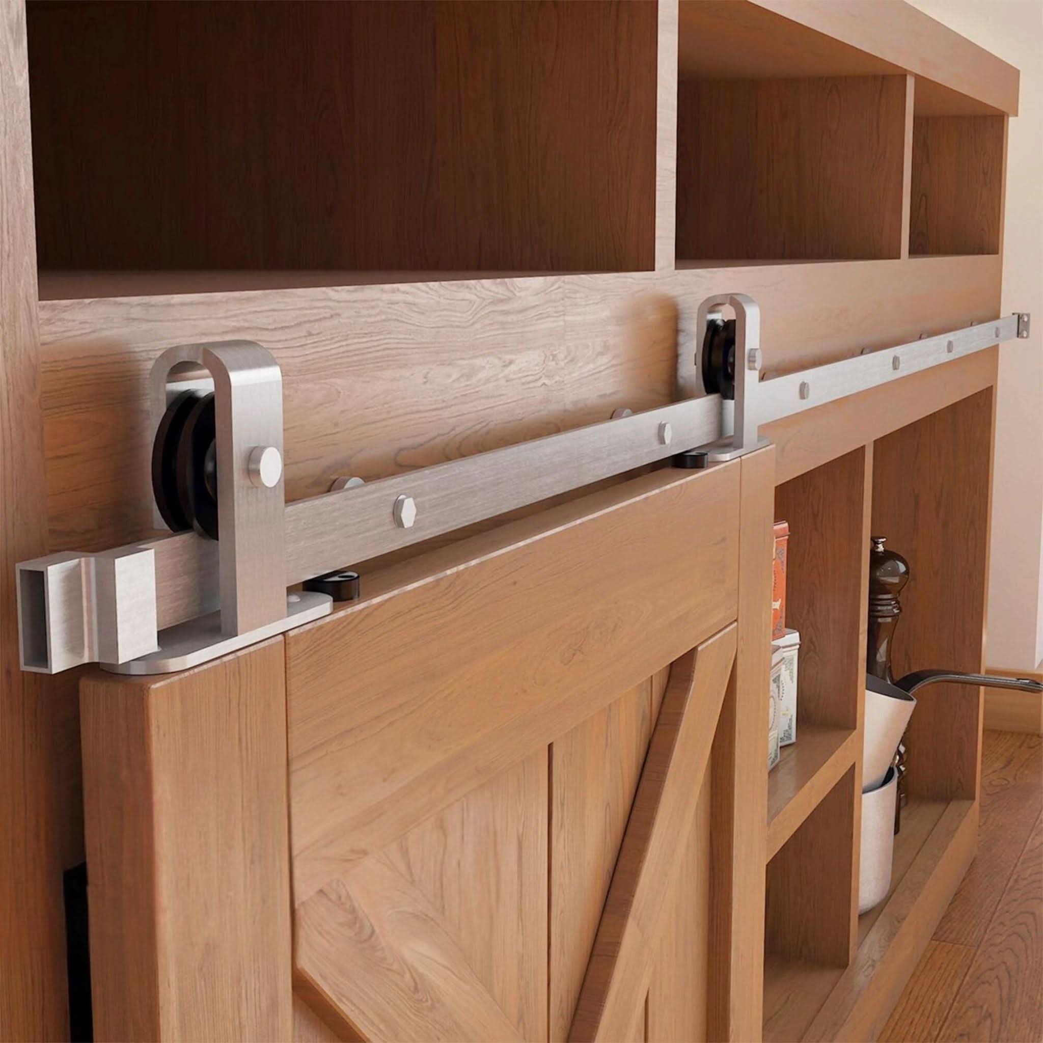 A J Top Mount cabinet barn door hardware kit in a brushed nickel finish, mounted on a small cabinet door.