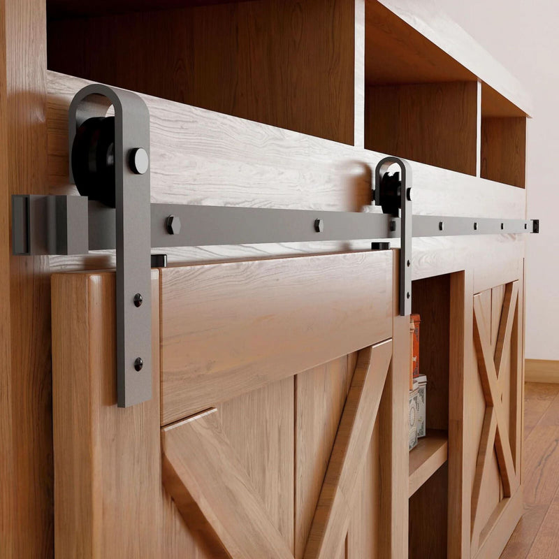 Classic J-Strap cabinet barn door hardware kit in a matte black finish, mounted on a small cabinet door.