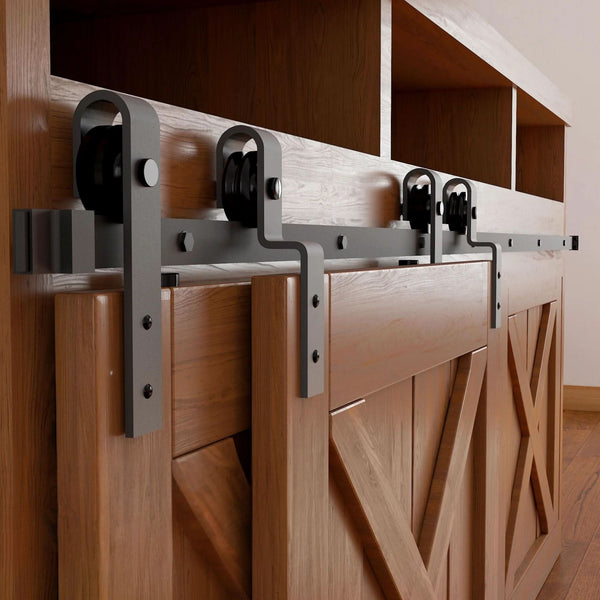 Matte black J-Strap mini bypass cabinet barn door hardware kit on a single track, shown on a small two-door wooden cabinet.