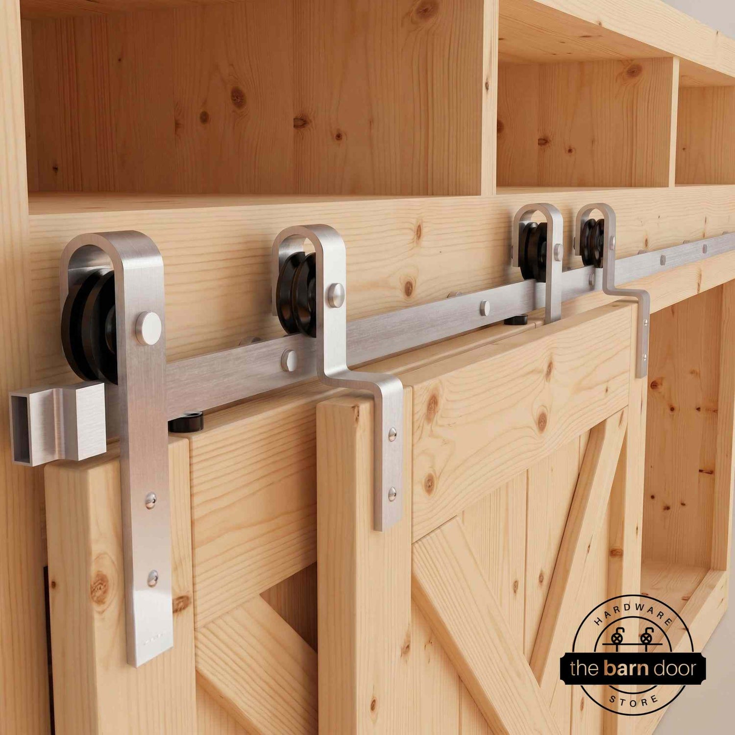 Brushed nickel J-Strap mini bypass cabinet barn door hardware kit on a single track, installed on a small two-door wooden cabinet.