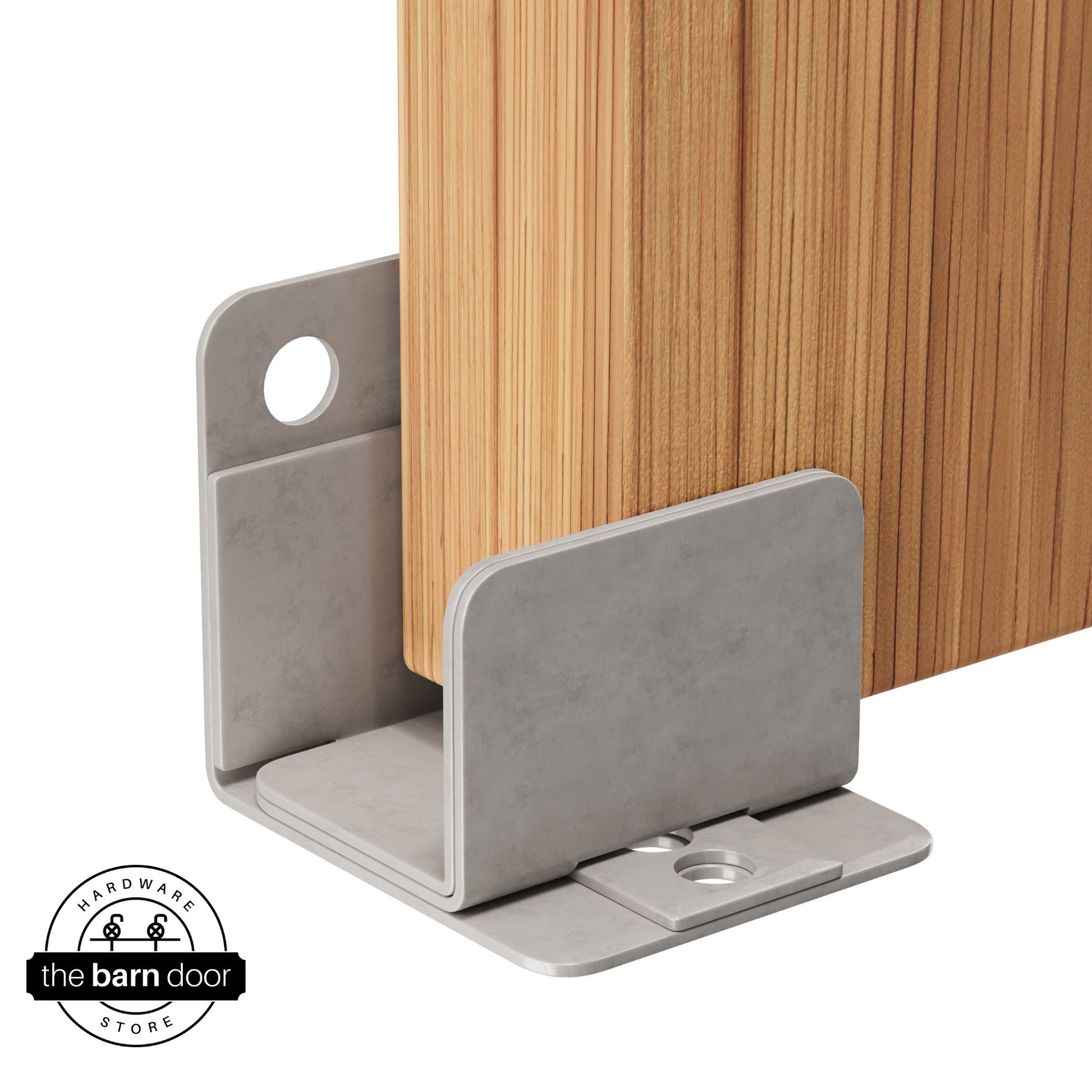 A raw steel U-shaped floor guide with a side plate, holding a light wood barn door in place.
