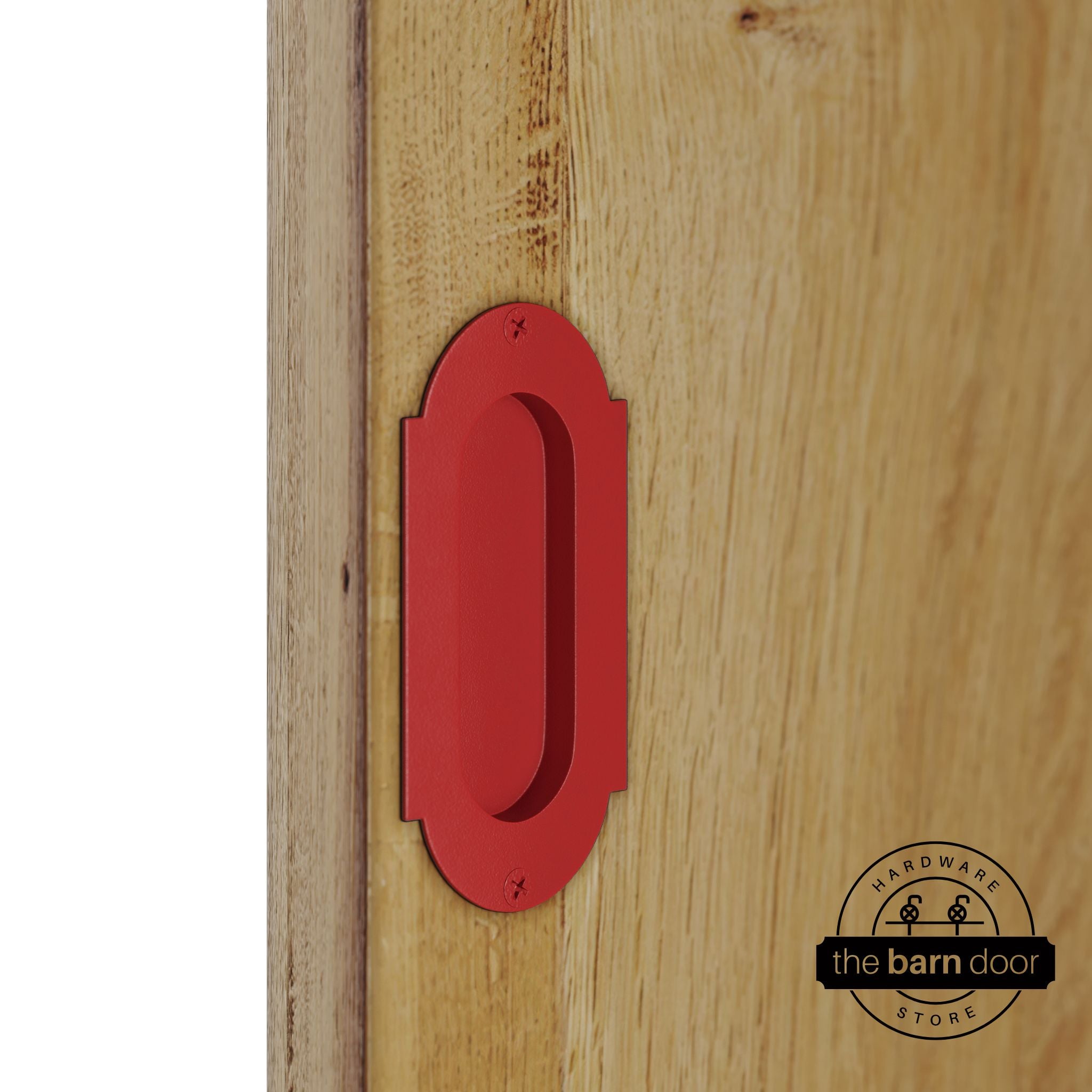Red flush pull handle with full radius wings mounted on a light oak barn door, brushed silver finish with oval recessed grip and four mounting screws