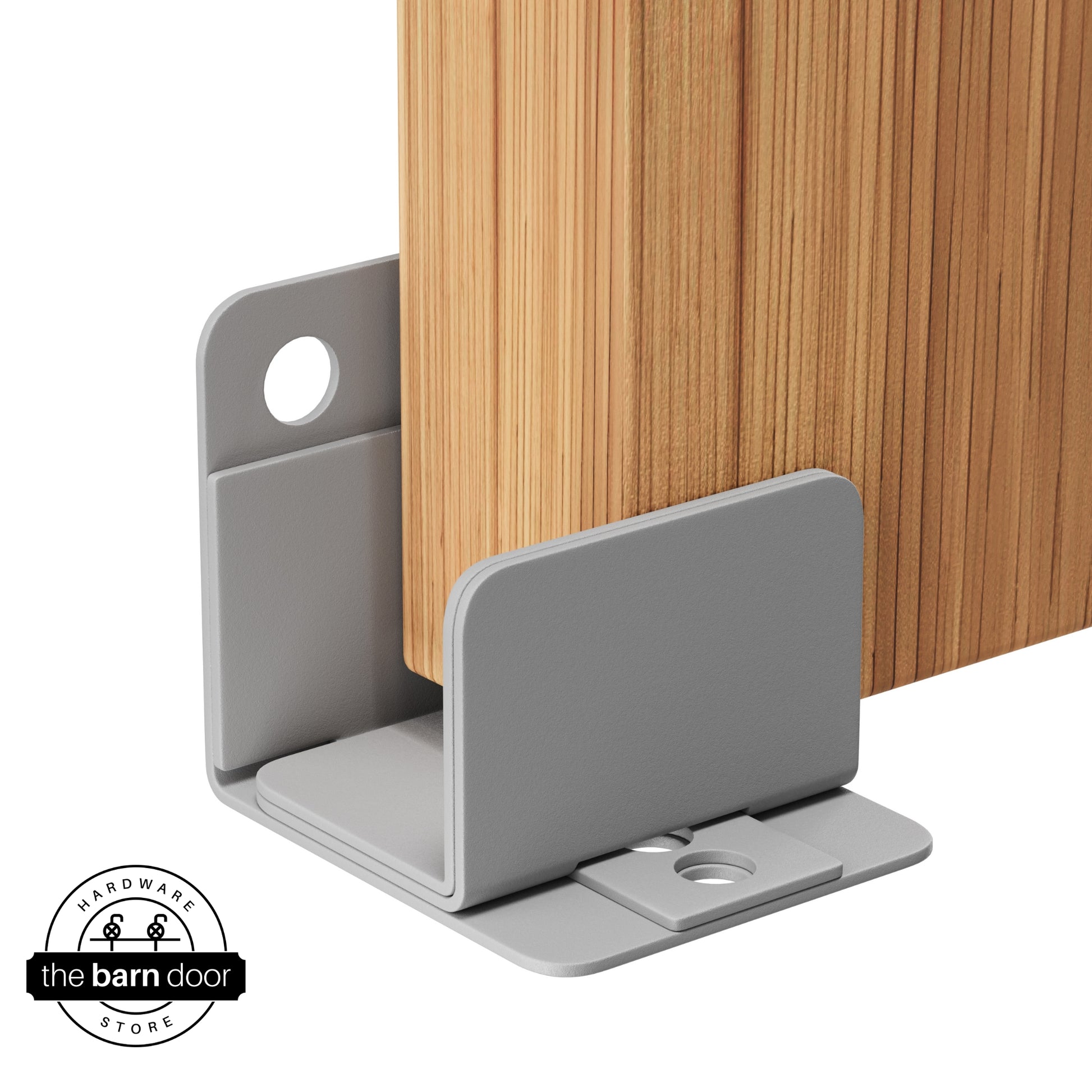 A silver metalli U-shaped floor guide with a side plate, holding a light wood barn door in place.