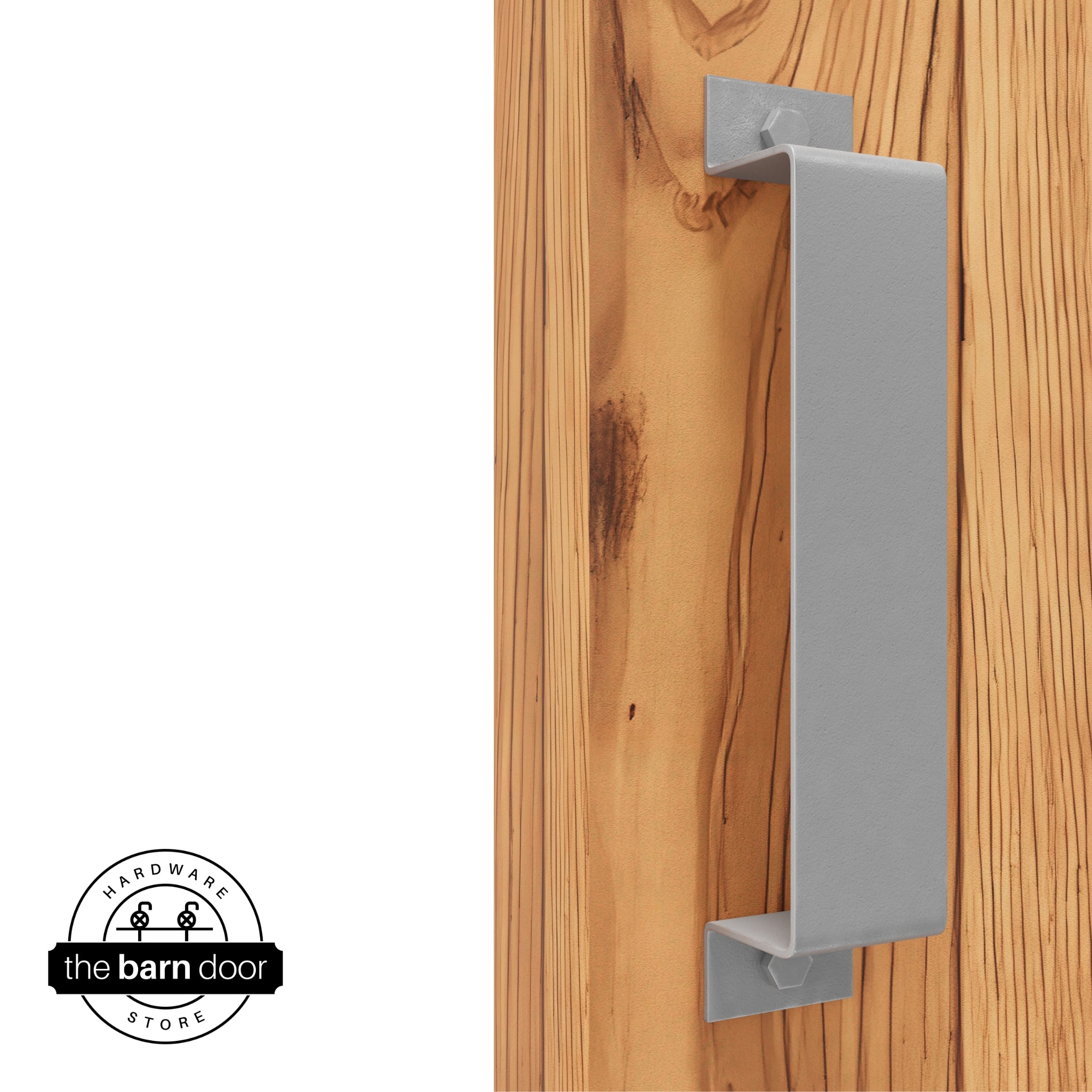 A silver metallic, arch-shaped barn door handle is mounted on a light-colored wooden door with a vertical grain pattern.