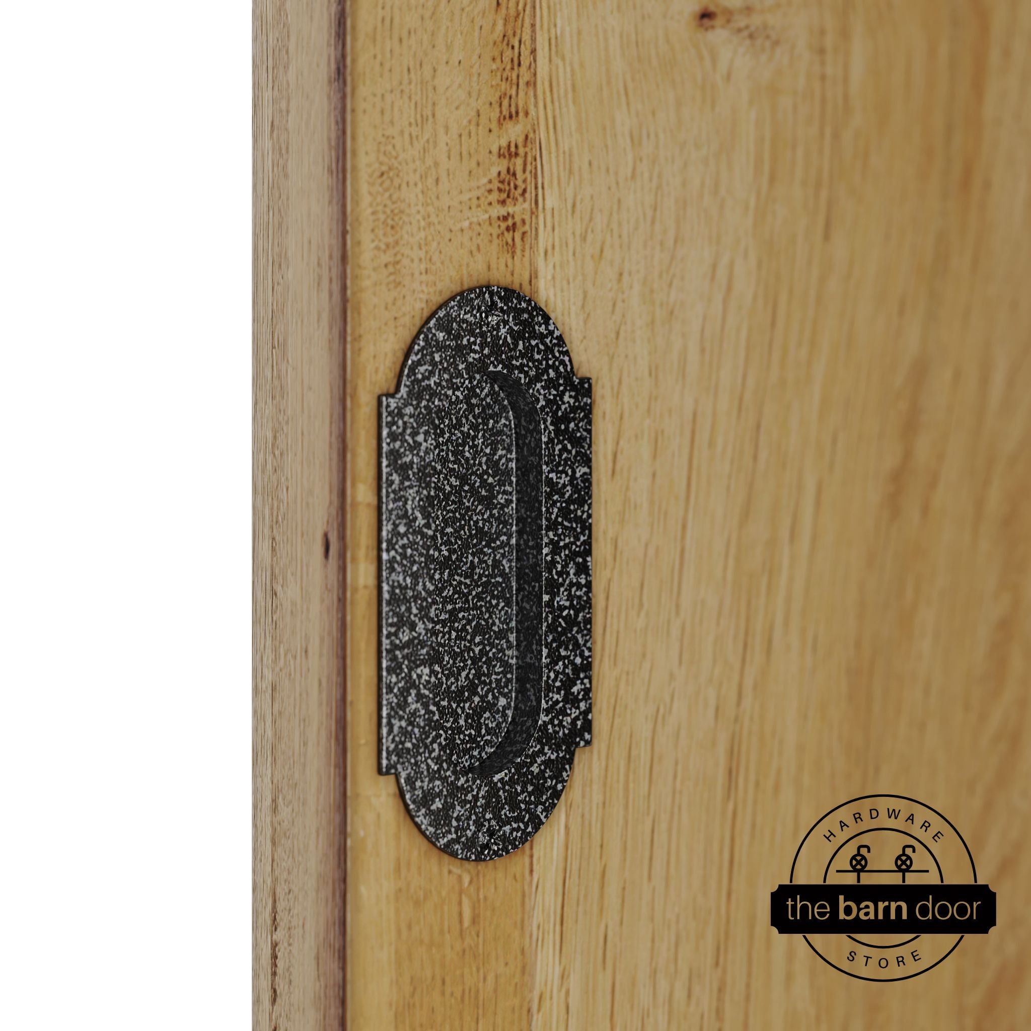 Silver vein flush pull handle with full radius wings mounted on a light oak barn door, brushed silver finish with oval recessed grip and four mounting screws