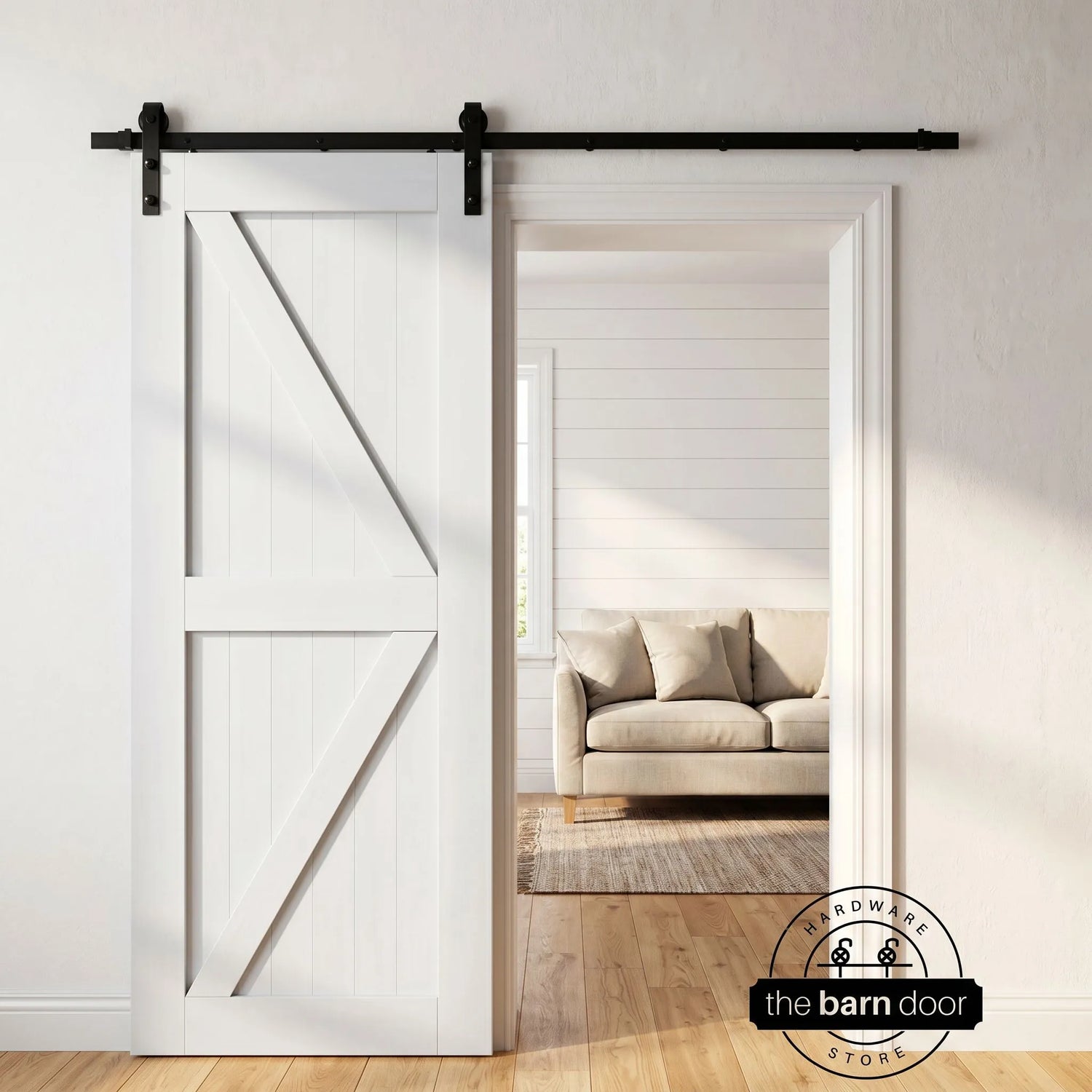 A white Z-brace barn door creates a classic farmhouse look, hung with a black J-strap kit, an ideal and popular Quick Ship DIY barn door hardware choice.