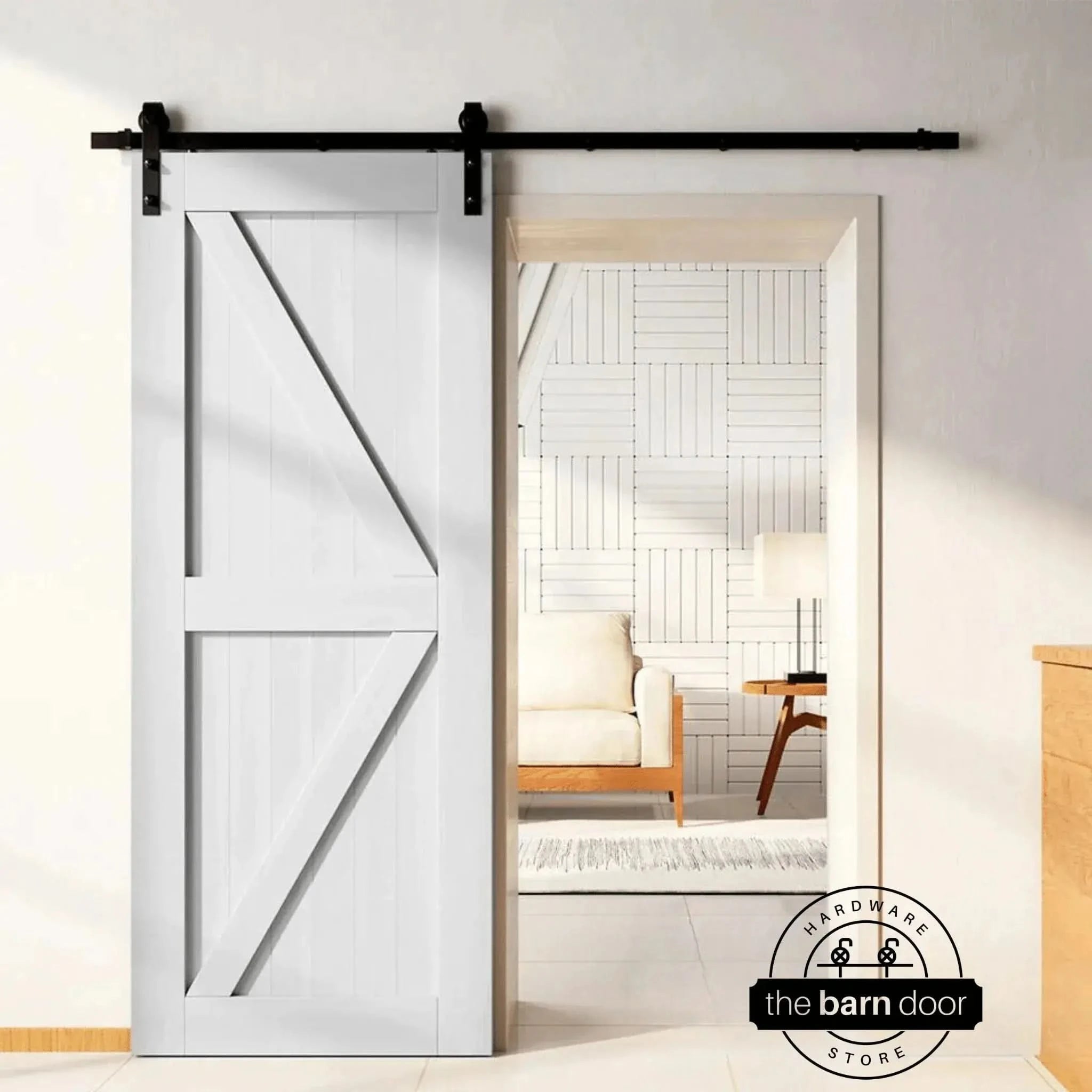 A white Z-brace barn door creates a classic farmhouse look, hung with a black J-strap kit, an ideal and popular Quick Ship DIY barn door hardware choice.