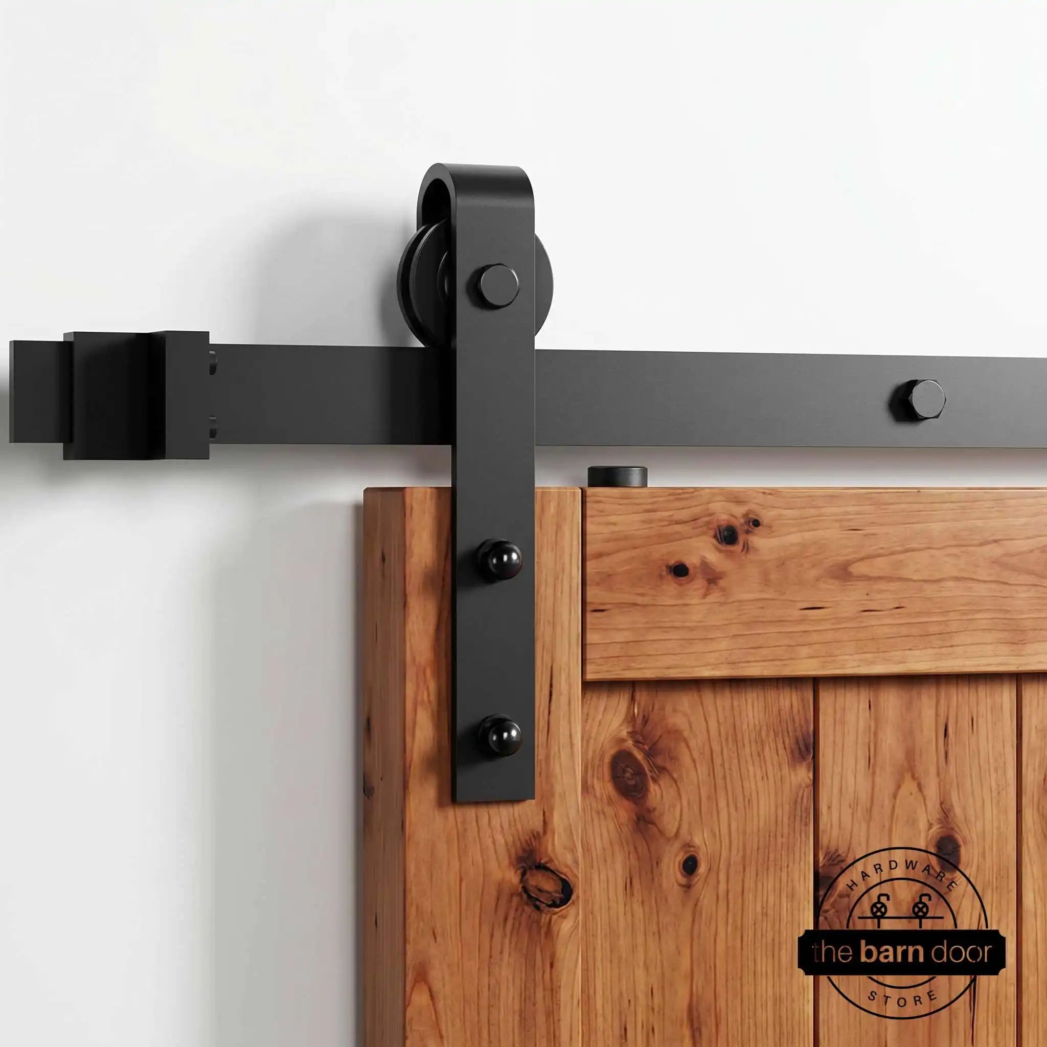 The complete J-Strap black single track barn door hardware kit displayed on a white background, with all installation components laid out for viewing.