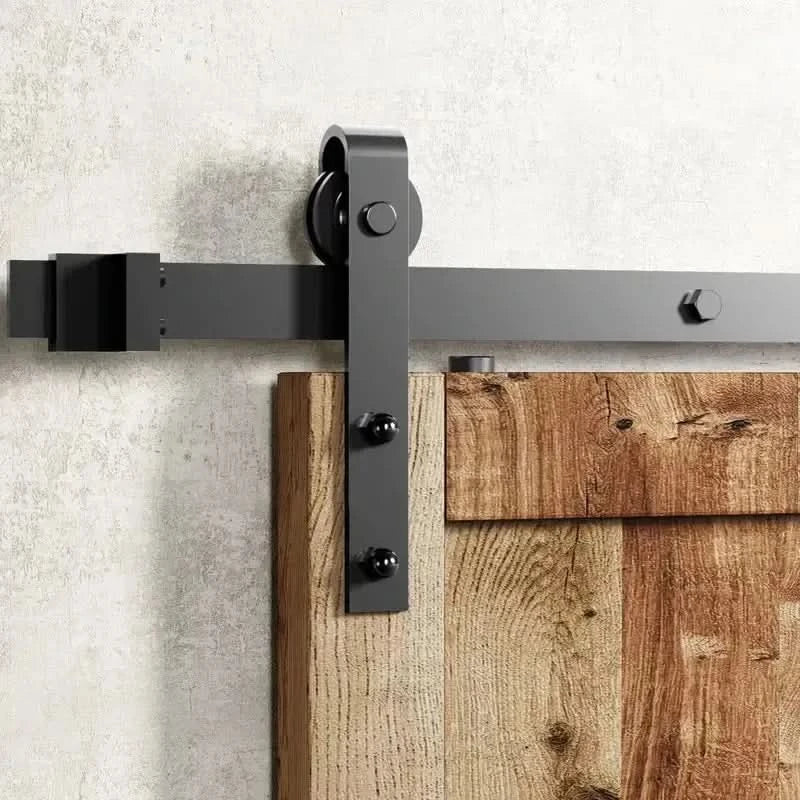 The complete J-Strap black single track barn door hardware kit displayed on a white background, with all installation components laid out for viewing.