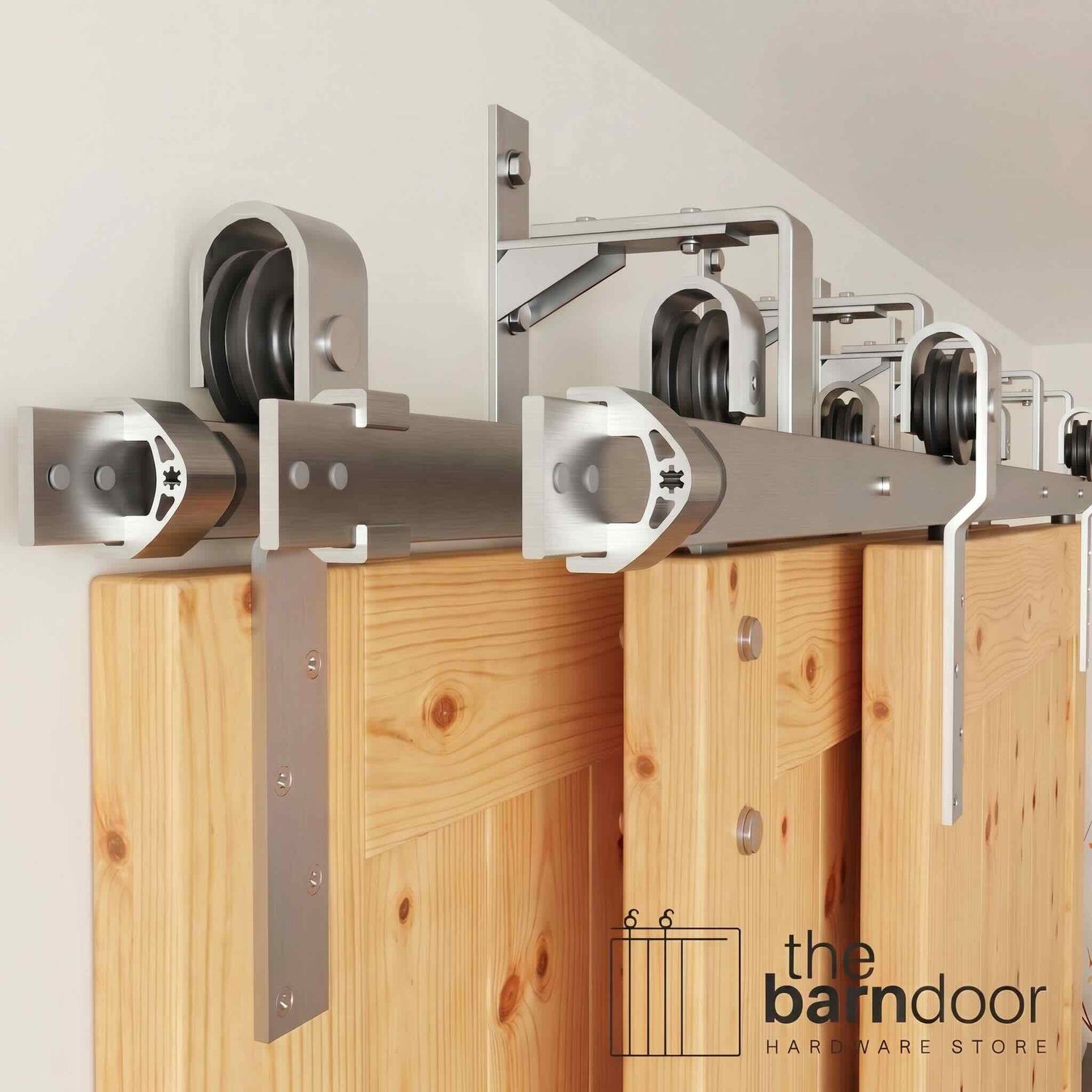 J-Strap Triple Track Bypass Barn Door Hardware Kit in a brushed nickel finish, showing three barn doors on a multi-track system.