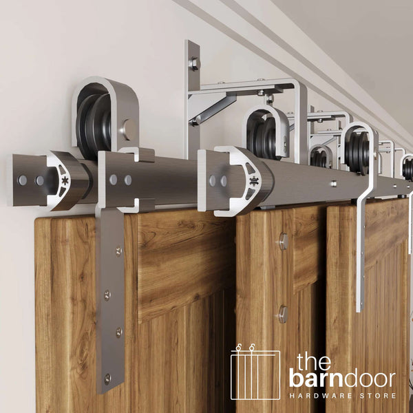 J-Strap Triple Track Bypass Barn Door Hardware Kit in a brushed nickel finish, showing three barn doors on a multi-track system.