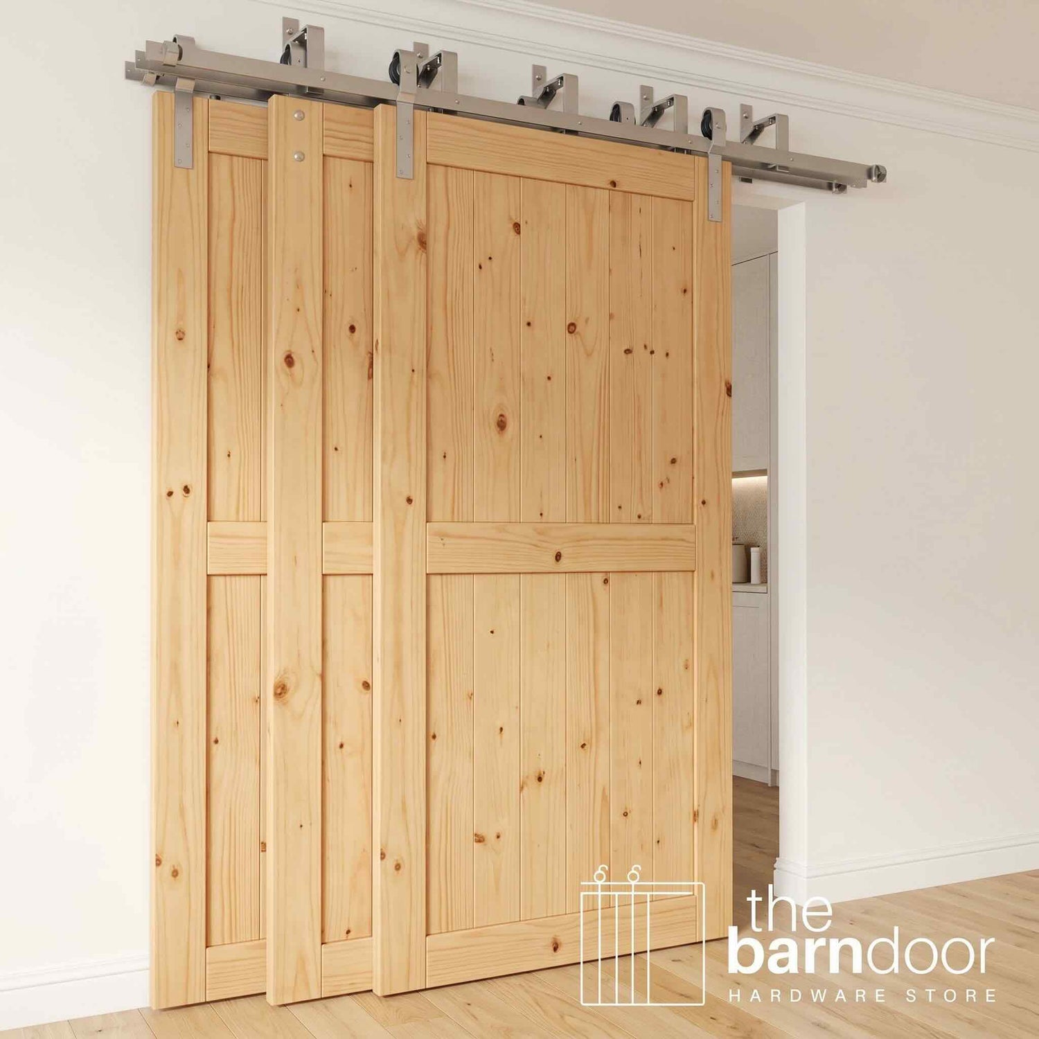 J-Strap Triple Track Bypass Barn Door Hardware Kit in a brushed nickel finish, showing three barn doors on a multi-track system.