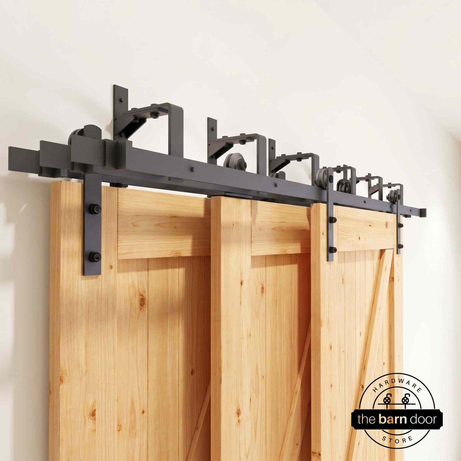 Straight Strap Triple Track Bypass Barn Door Hardware Kit in matte black, showing three barn doors on a multi-track system.