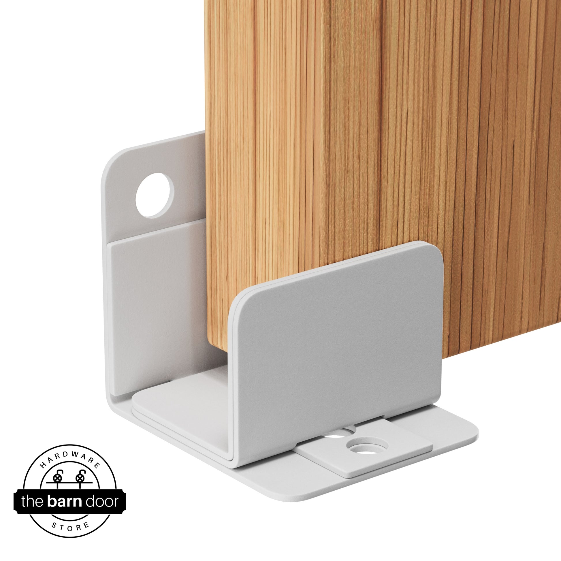 A rocket white U-shaped floor guide with a side plate, holding a light wood barn door in place.