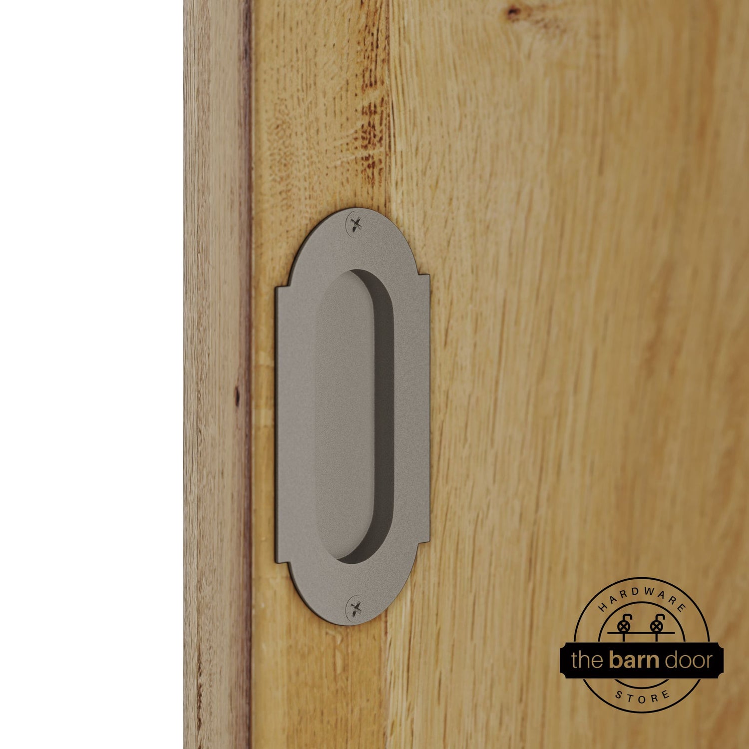 White bronze flush pull handle with full radius wings mounted on a light oak barn door, brushed silver finish with oval recessed grip and four mounting screws
