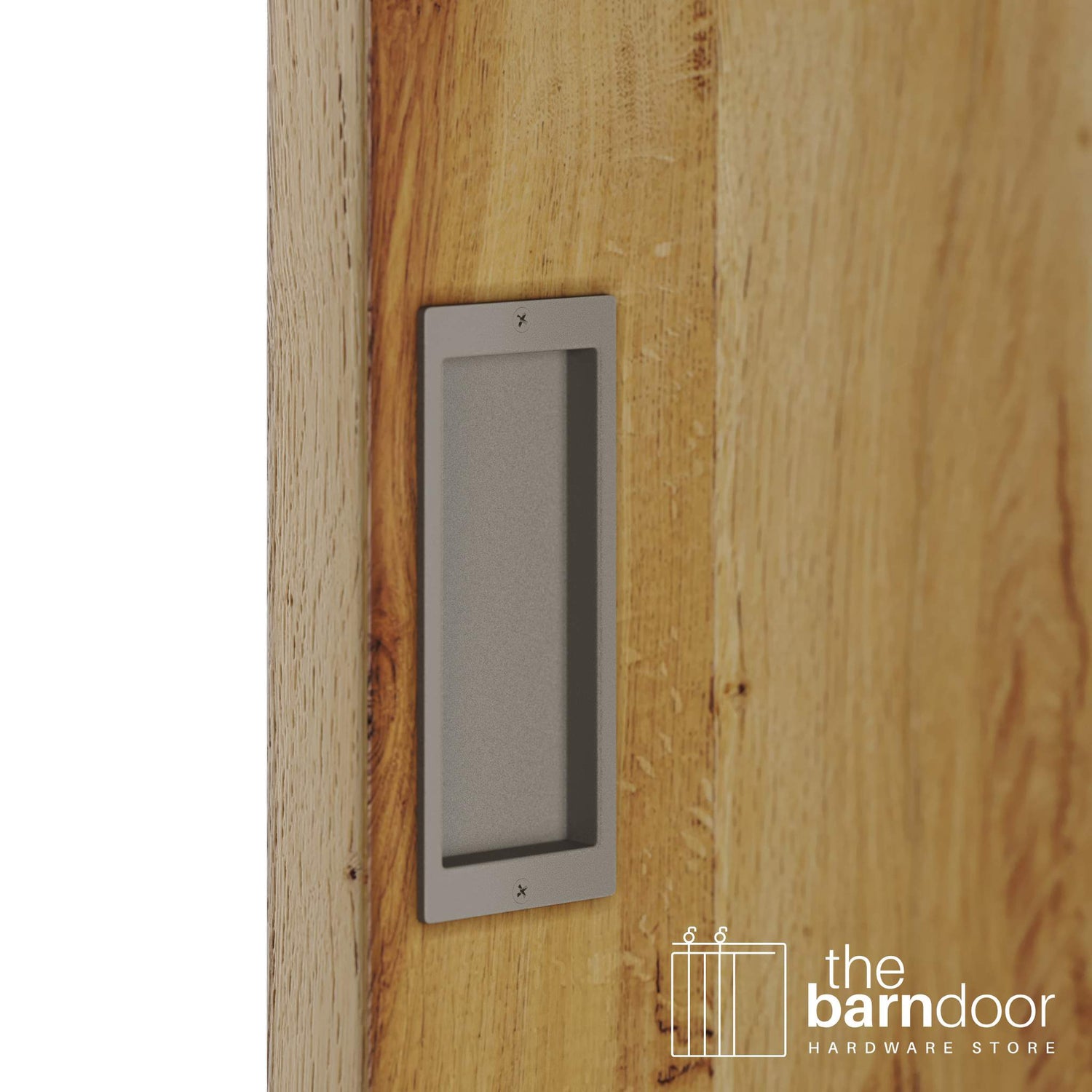 A close-up shot of a recessed rectangular flush pull handle in a white bronze finish, installed on a light brown wooden barn door.