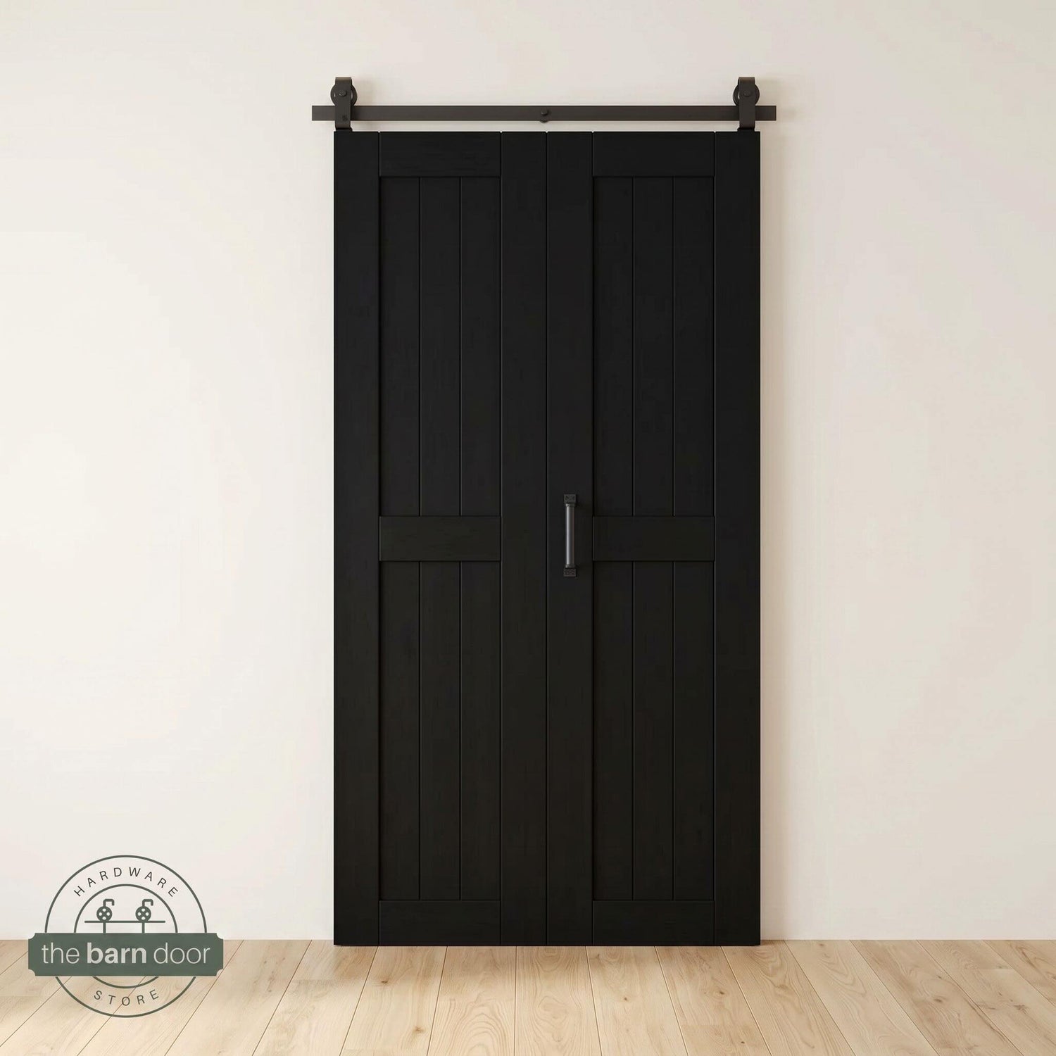 Two-panel bifold barn door in a black finish, installed and fully closed in a modern interior, showing the top-mount Matte Black track.
