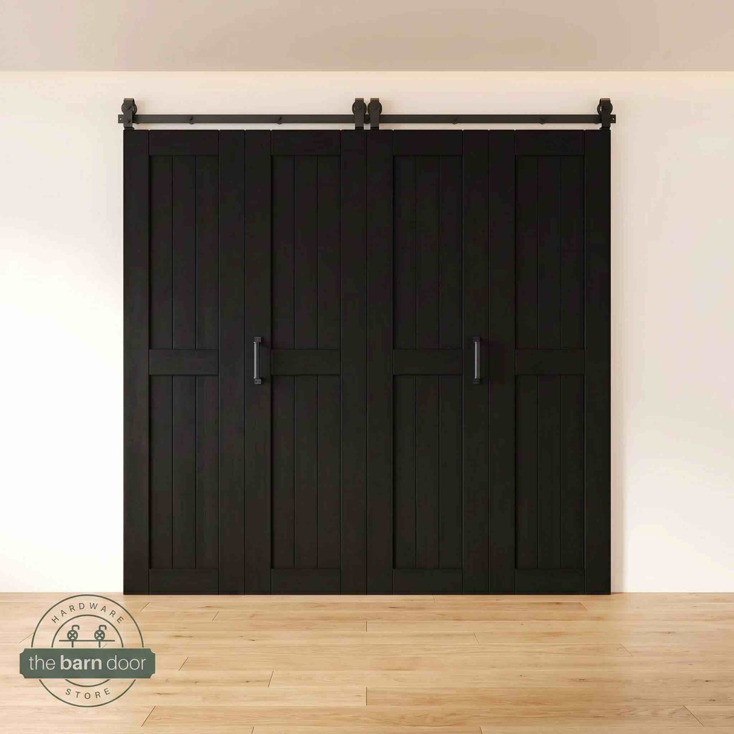 Four-panel bi-parting bifold barn door in a Black finish, fully closed in a modern entryway, showing the top-mount Matte Black track.