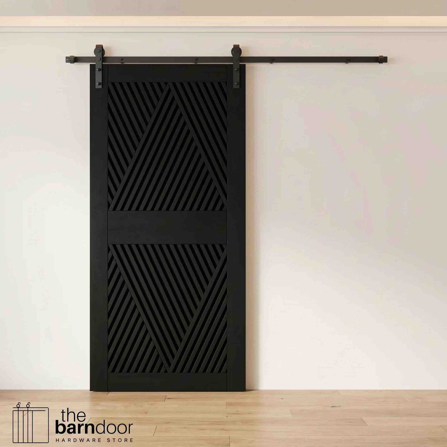 A modern black barn door with an intricate geometric diamond pattern installed on a black track in a contemporary living space with a fireplace.