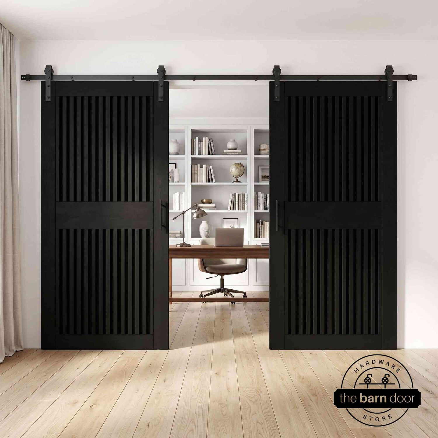 Black sliding barn doors with a modern fireplace in the background