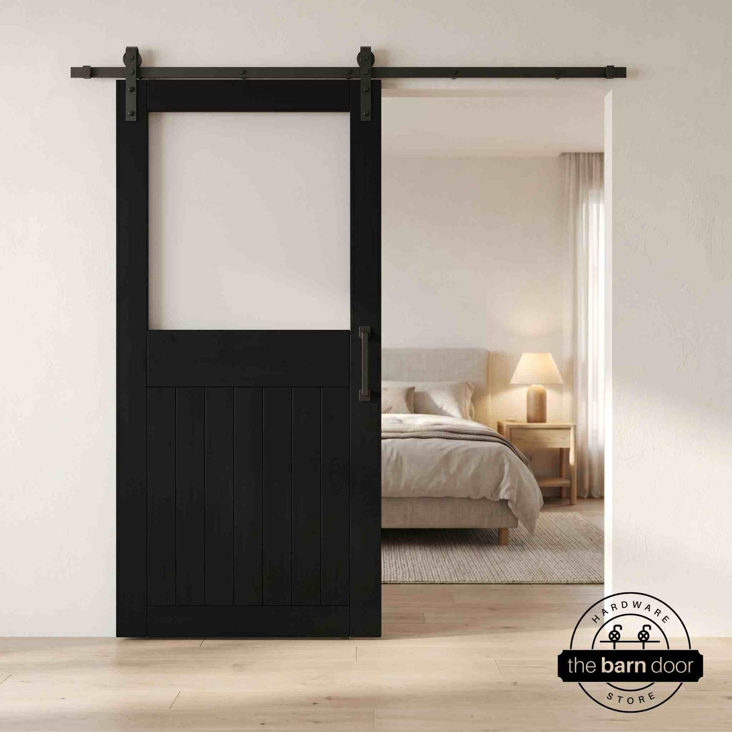 Black sliding half-lite frosted glass barn door in a modern interior setting with a desk and shelves.