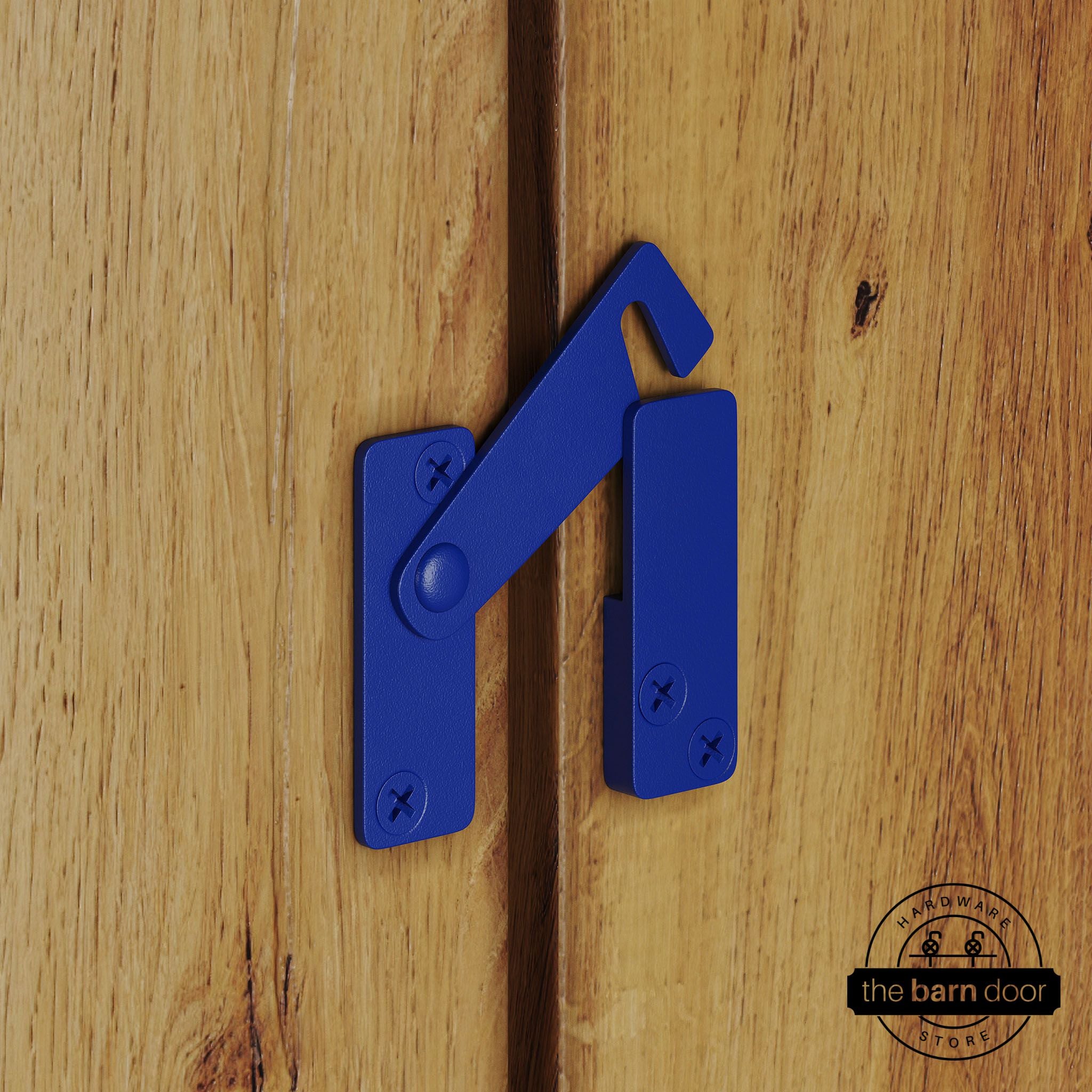 Blue privacy latch for biparting barn doors, shown latched across two wood door panels