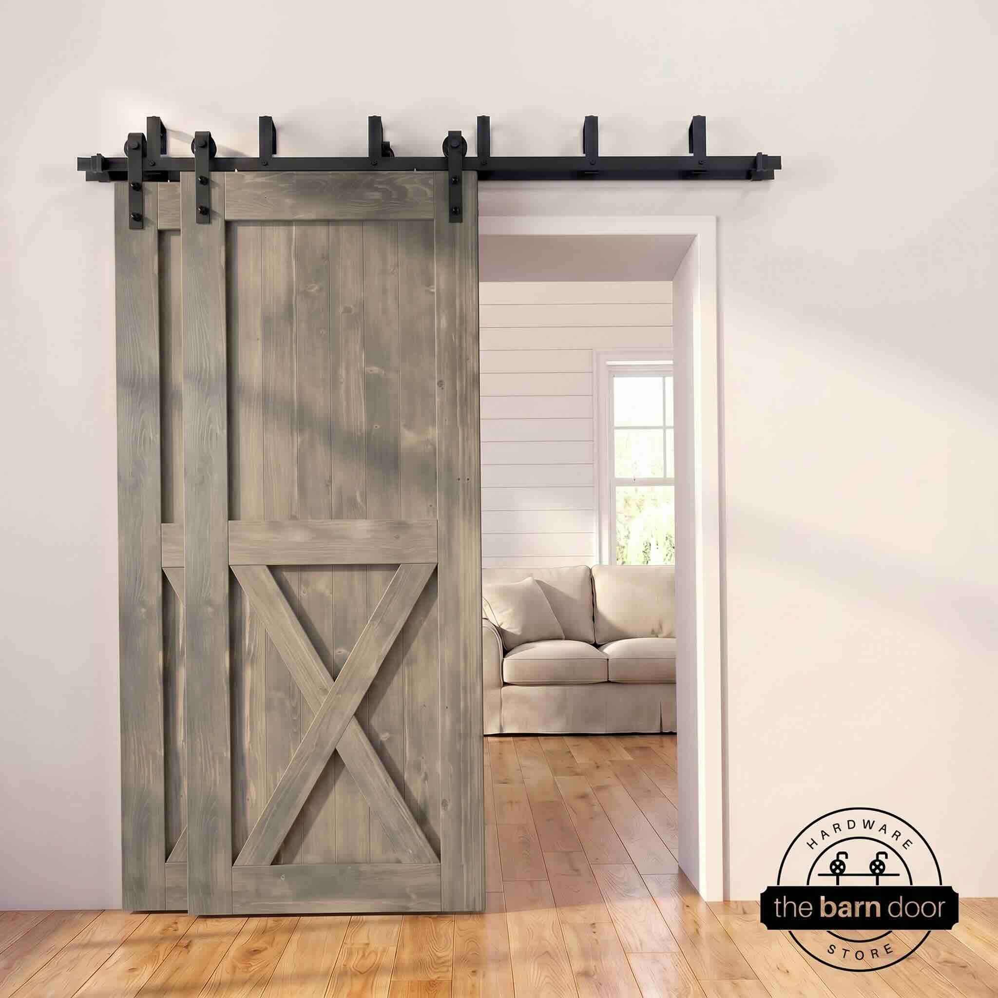 Classic gray pine bypass barn door with  black hardware track, mounted over living room entryway